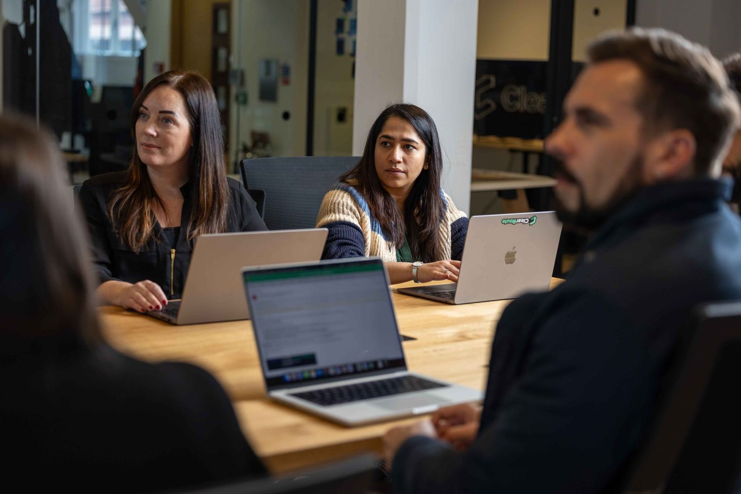 group meeting where they are all on lap tops and are looking towards a speaker