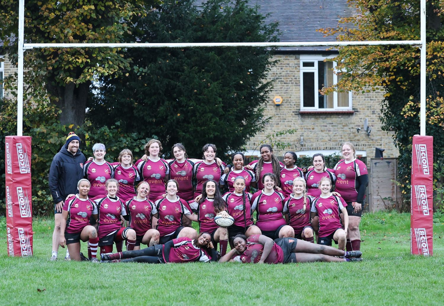 Team photo of a rugby team under the posts.