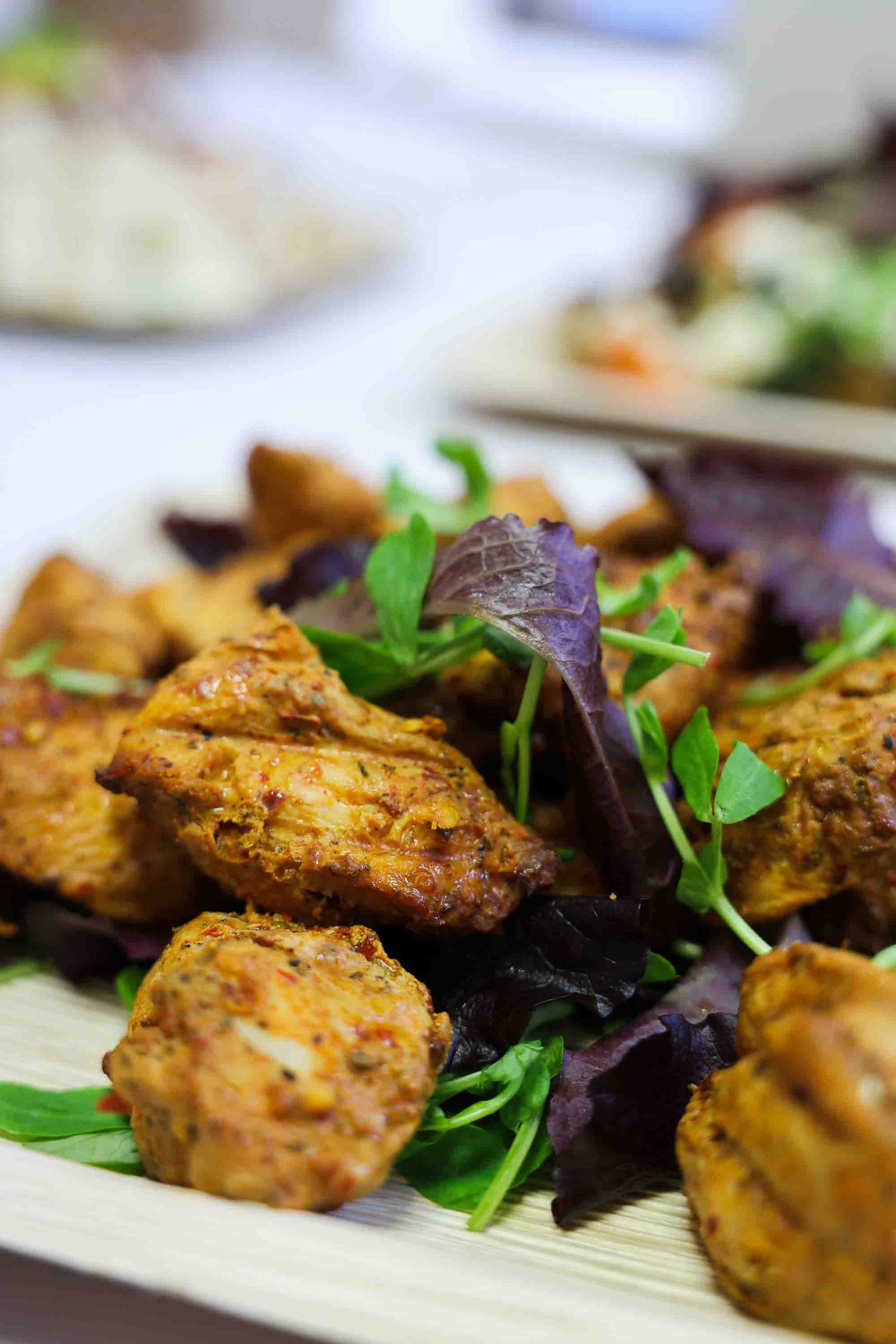 close up of the chicken on a plate with a garnish on top.