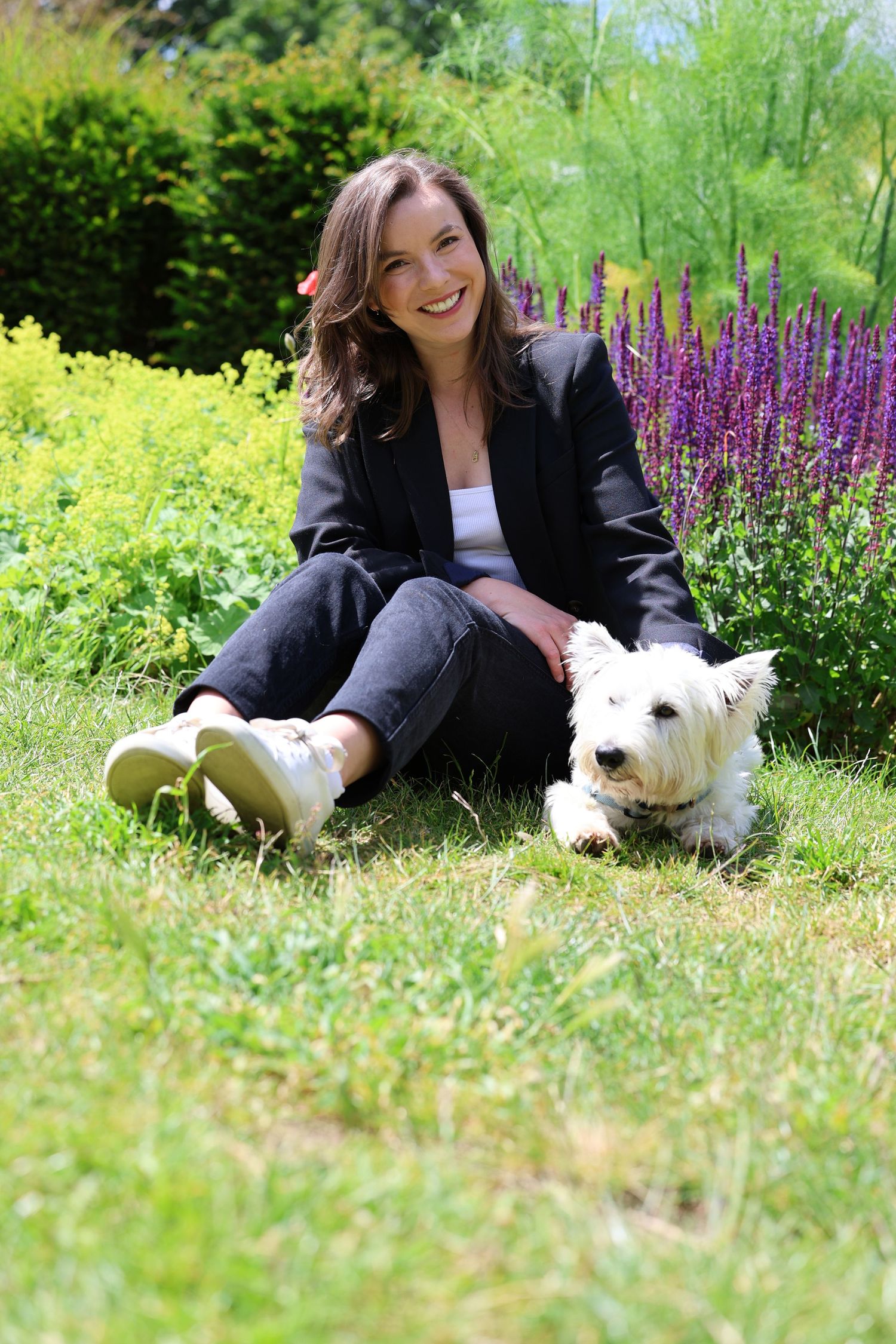 woman sat with her white dog