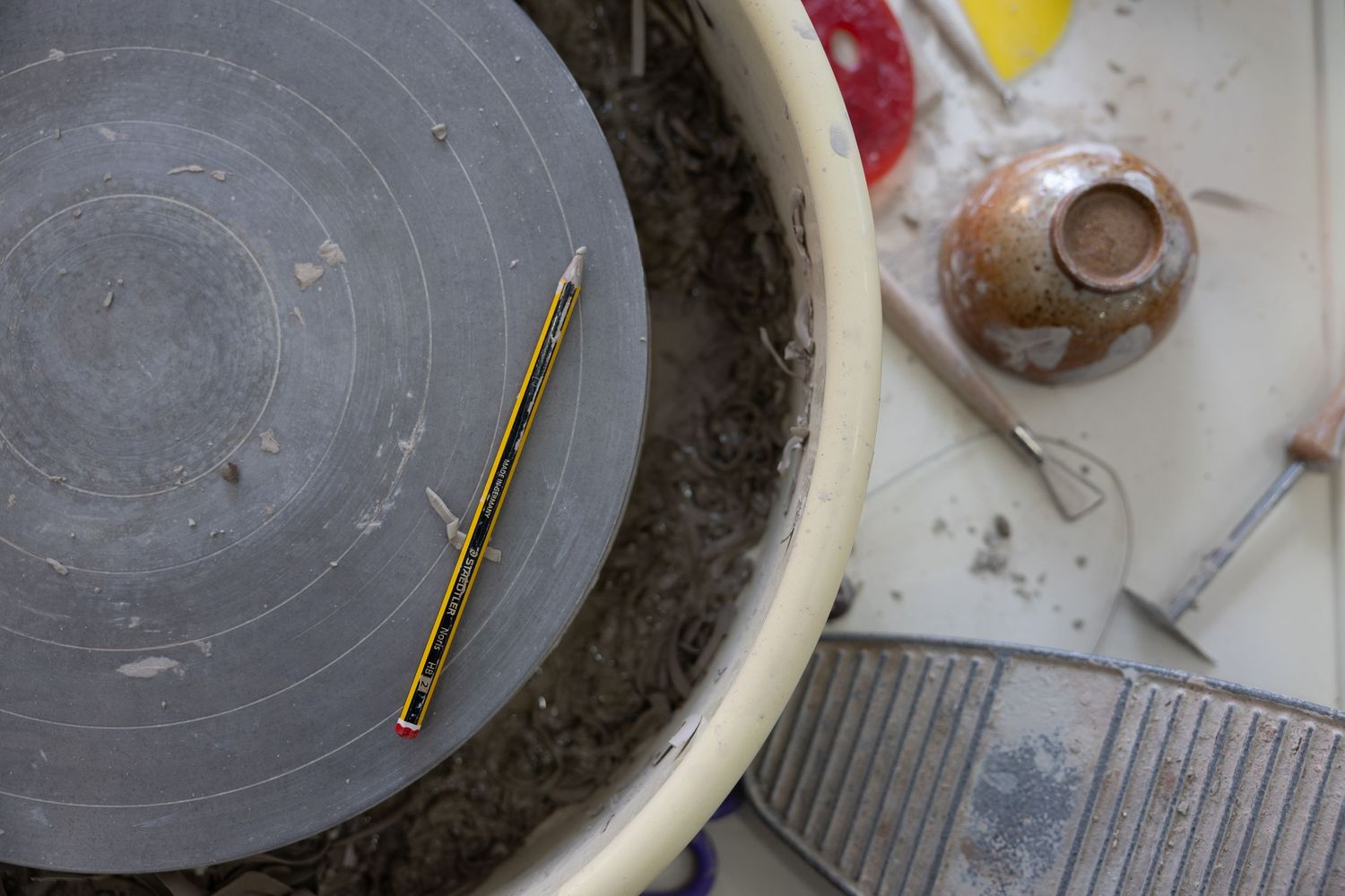 pottery wheel with pencil laid on it.