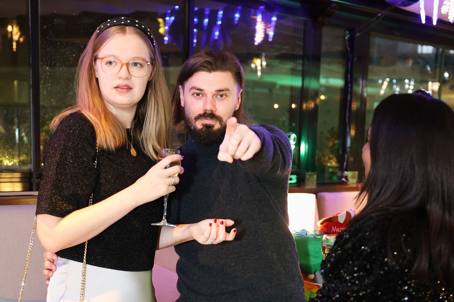 a man pointing at the camera at an event