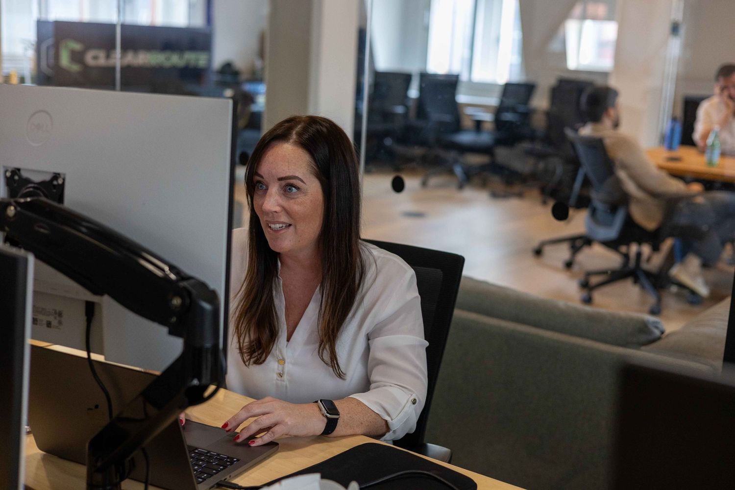 A woman in a white shirt at a computer