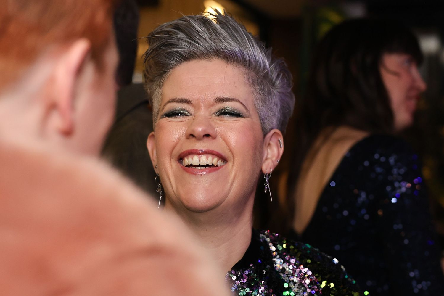 A woman with short purple hair having fun at the event
