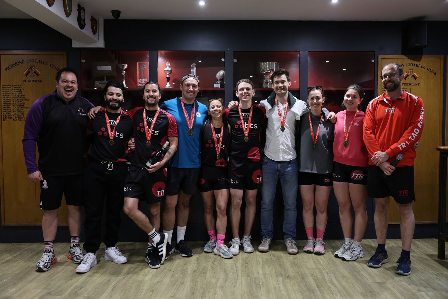 A team getting medals at a corporate sports event