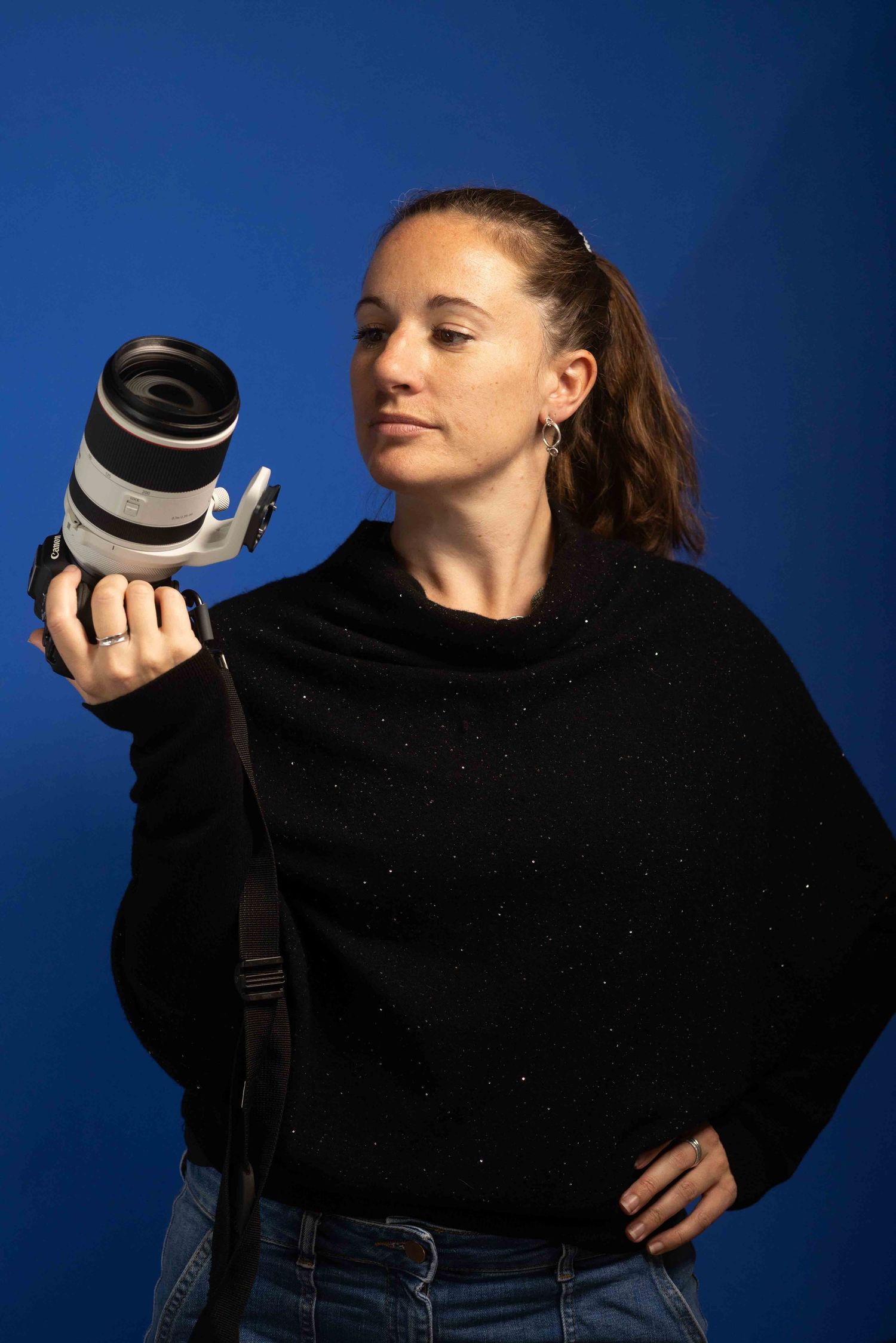 woman looking at the lens of her camera in ore,
