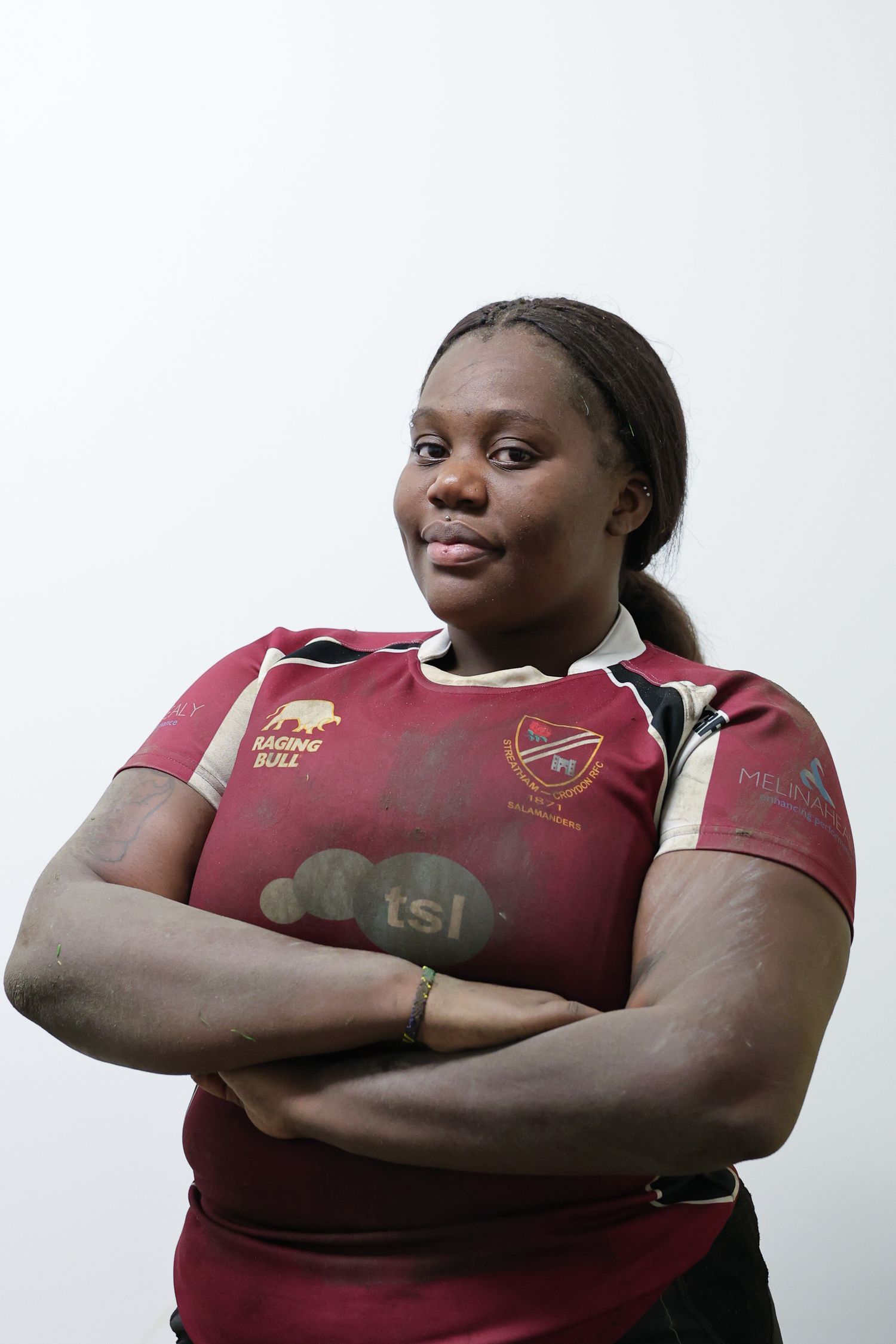 Portrait of a black woman standing with her arms crossed