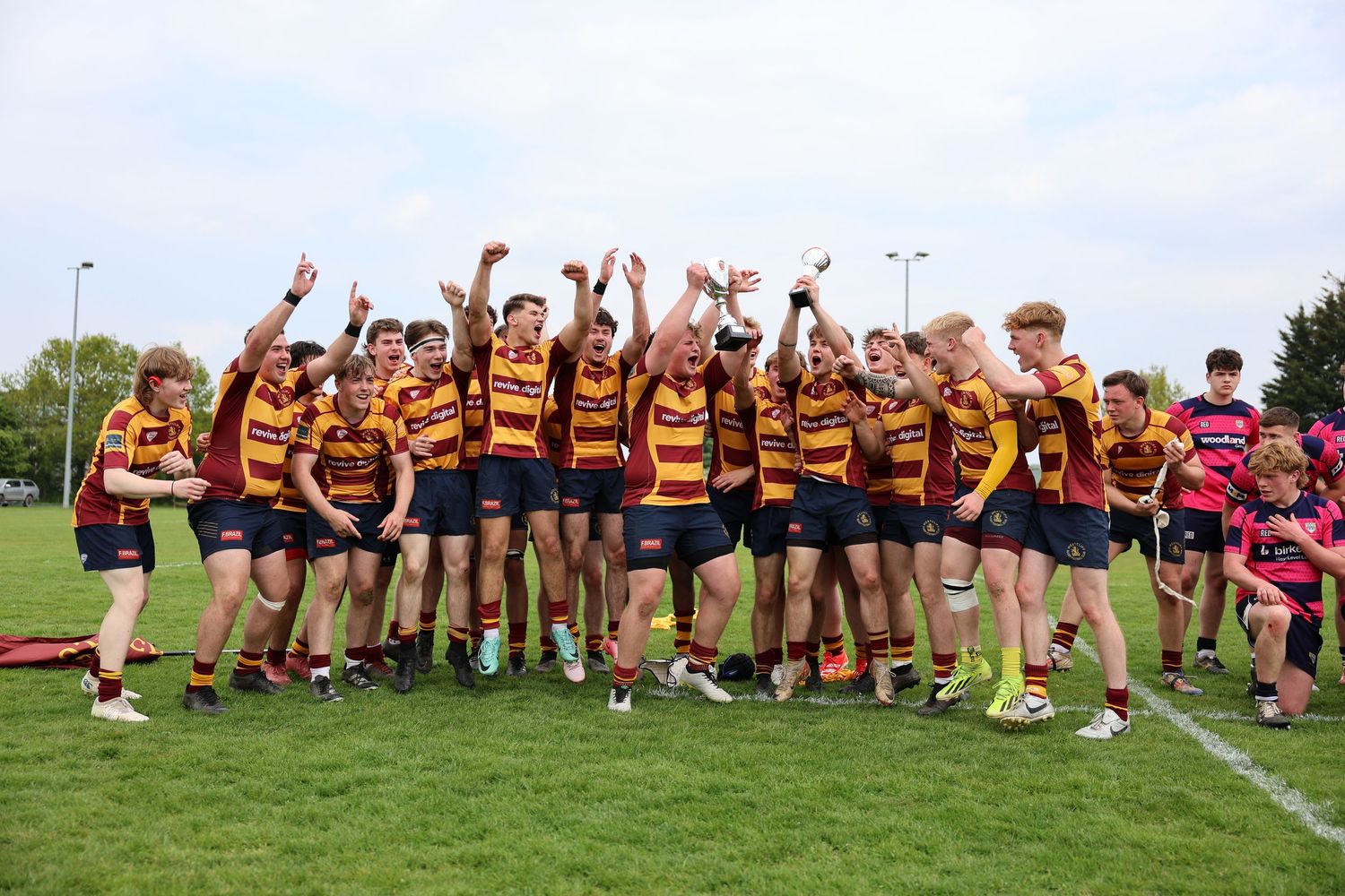 Team celebrating the win and raising the trophy