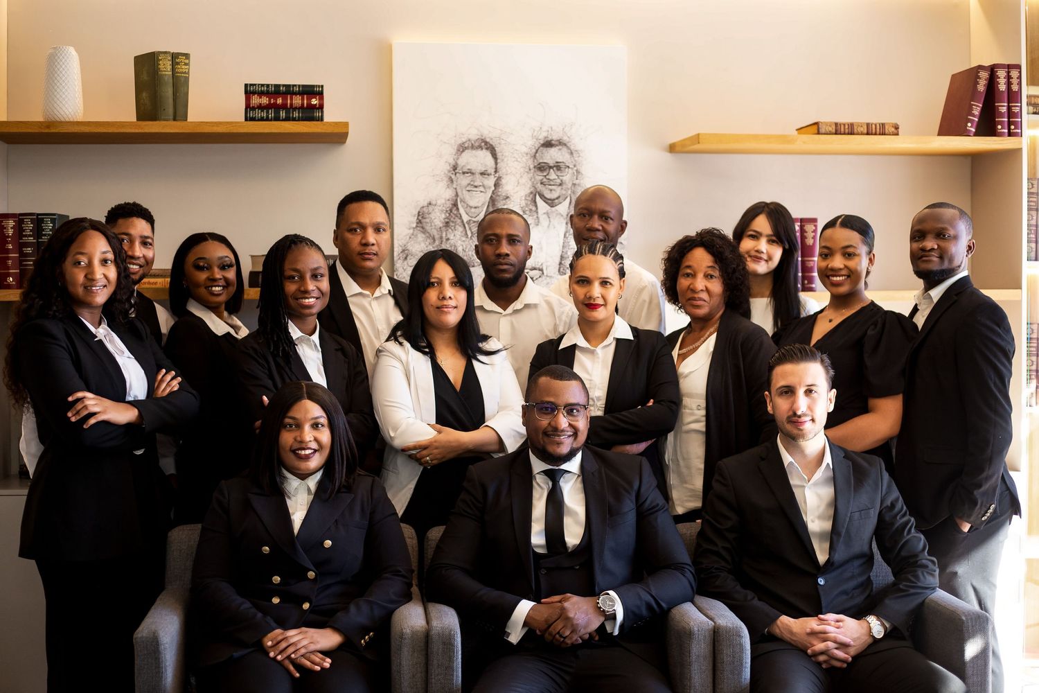 Group portrait of professional team members in formal business attire.