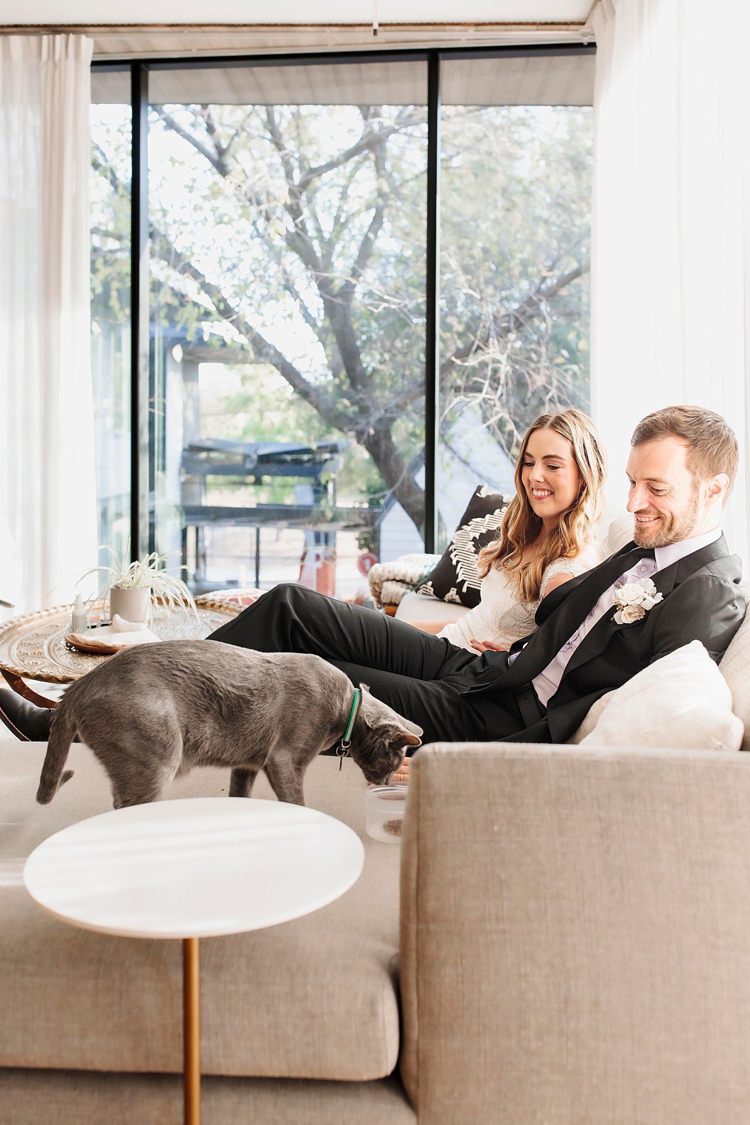 man and woman say hi to their cat for in-home portion of day by Claire Malaby Photography