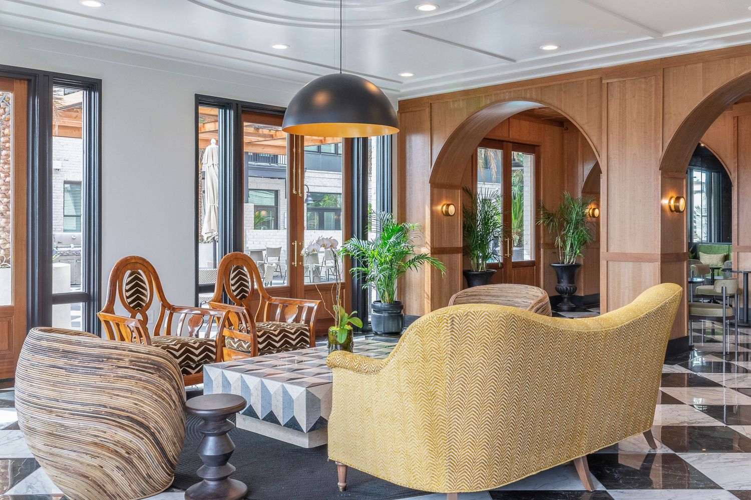 Luxury Savannah apartment lounge space with bohemian interior design complemented with bright green potted plants.