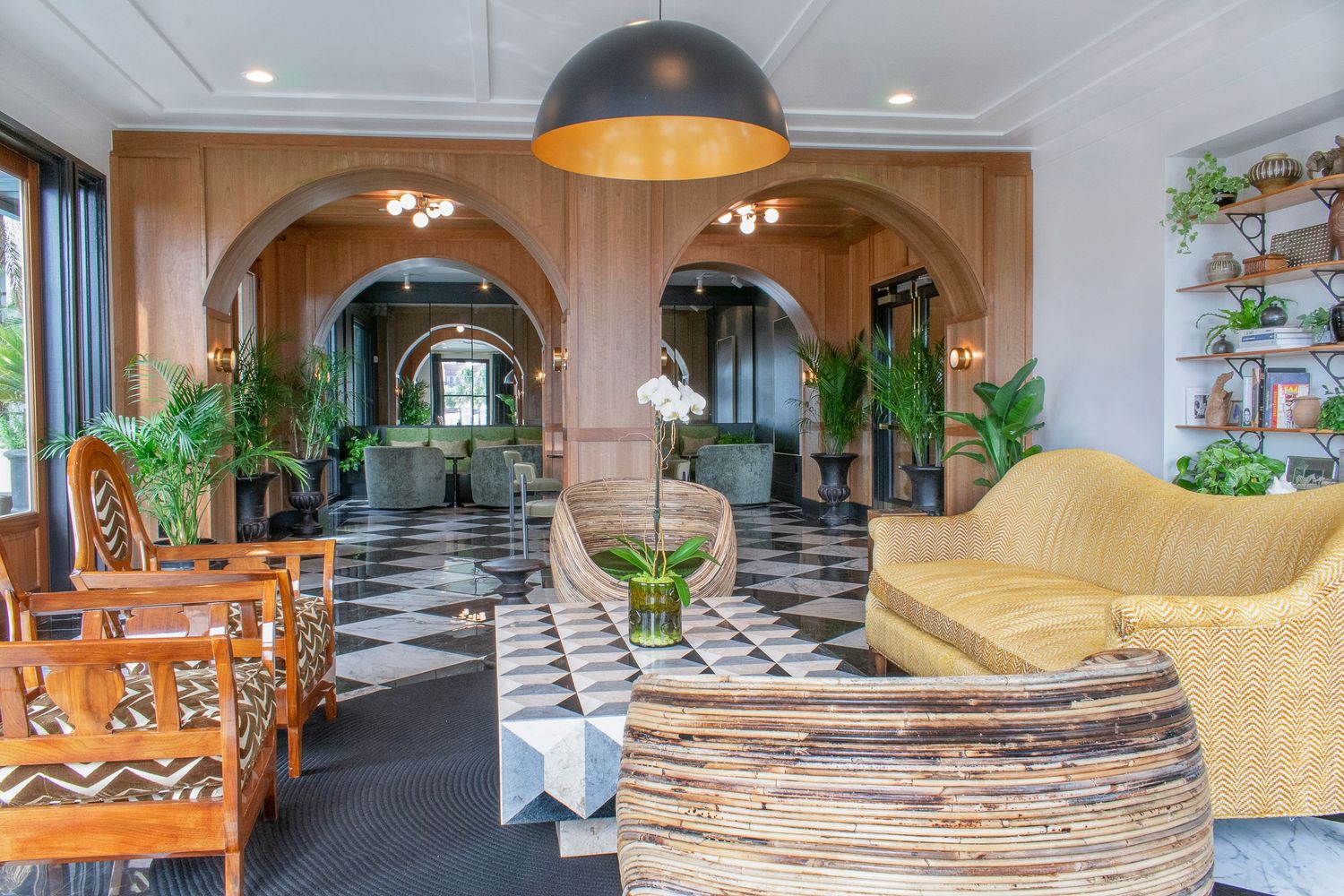Luxury Savannah apartment lounge space with bohemian interior design complemented with bright green potted plants.