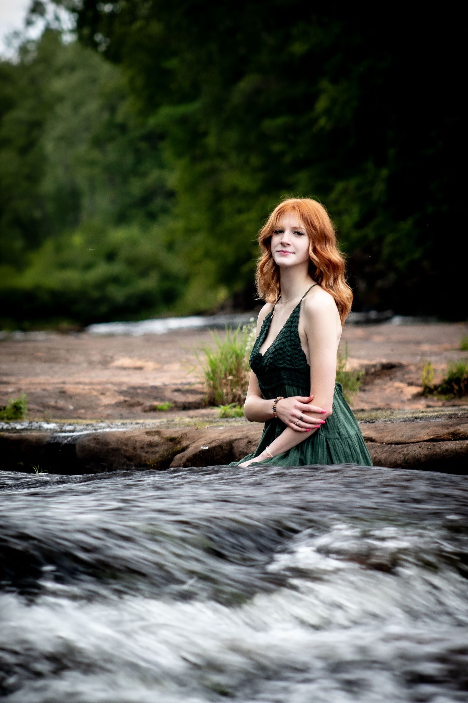 senior photography, girl sitting beside river in green dress