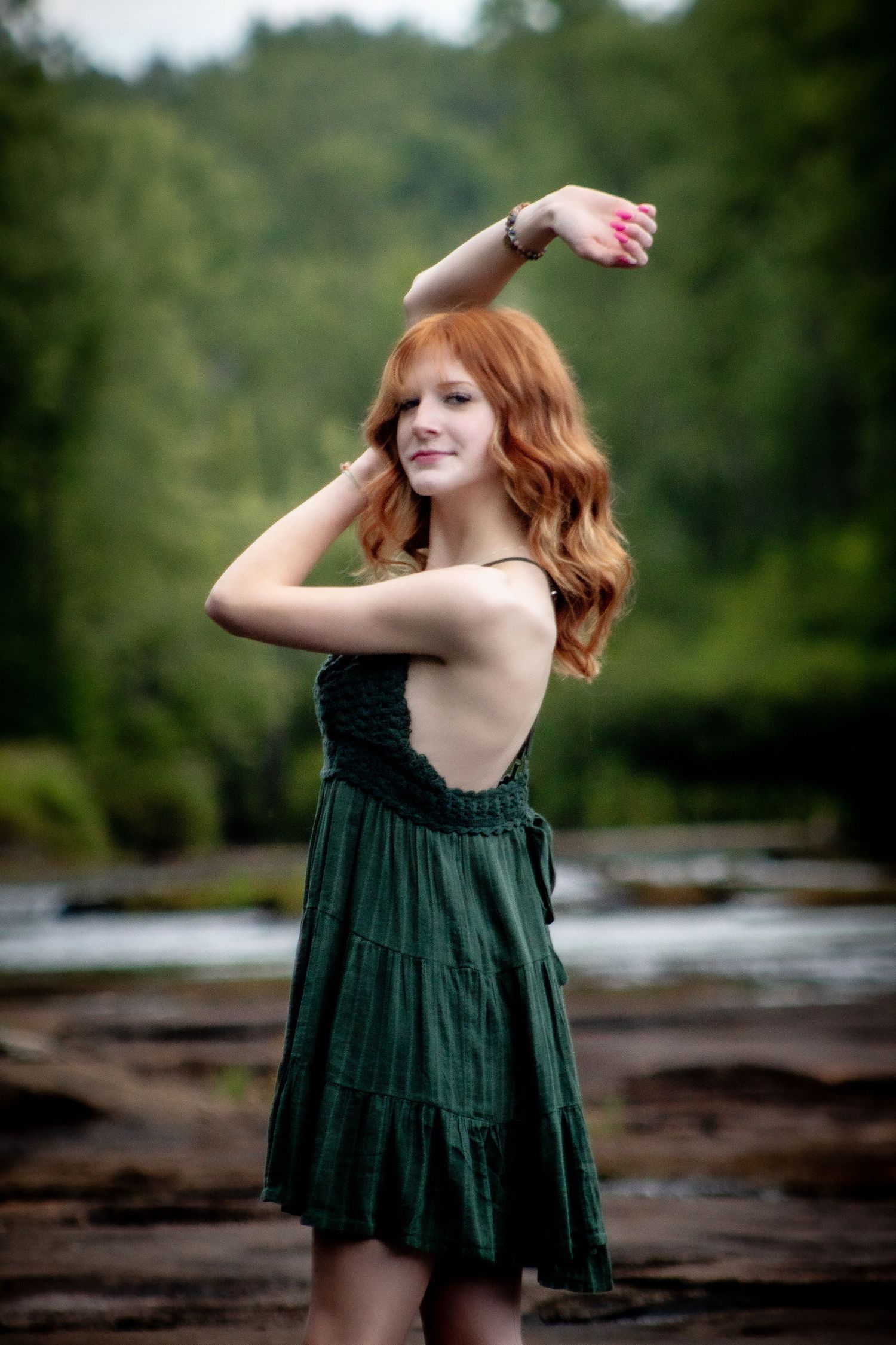 senior photography, girl in green dress, with river and trees in background