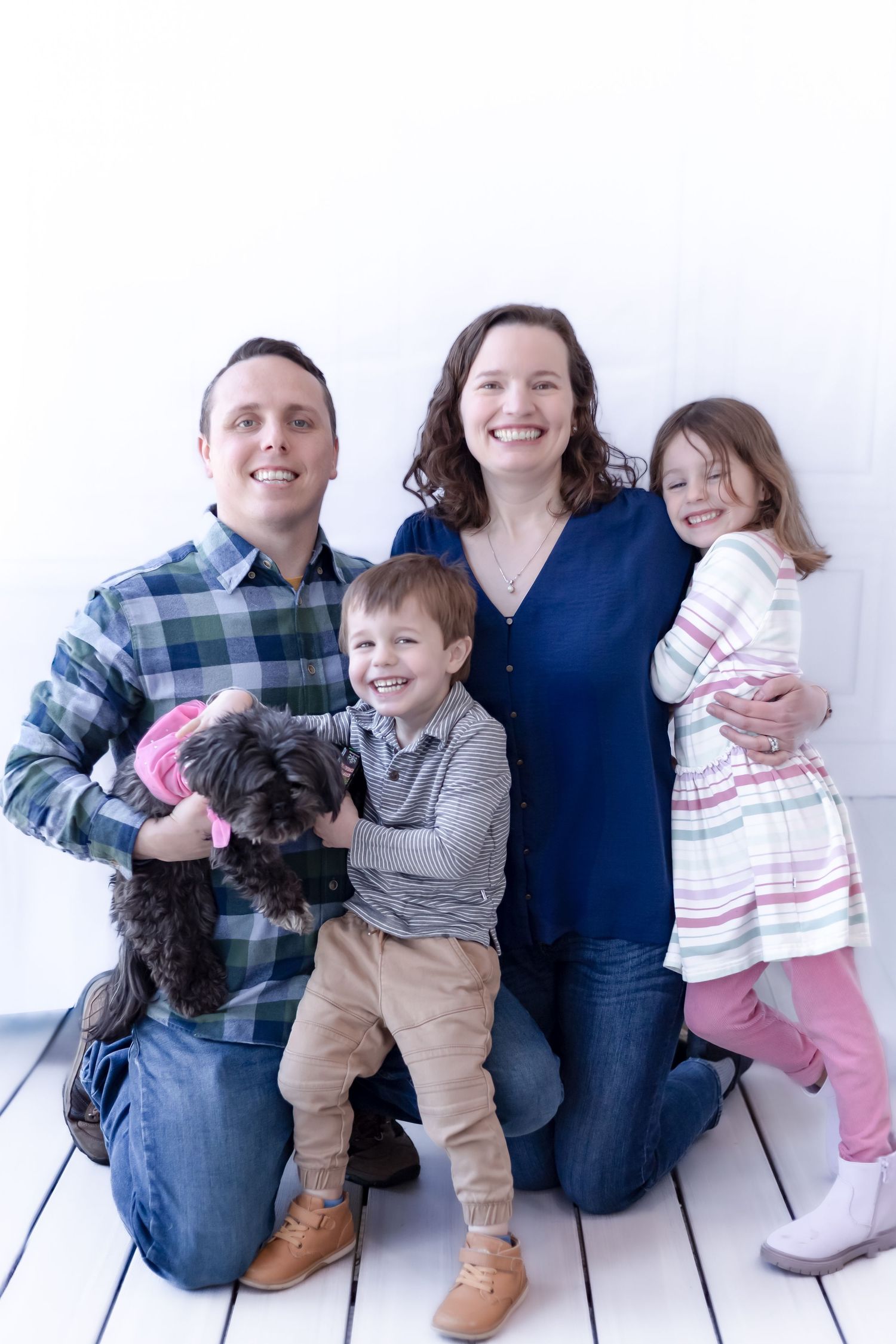 A series of three candid family photos showing parents and children sitting together with their dog against a white backdrop.