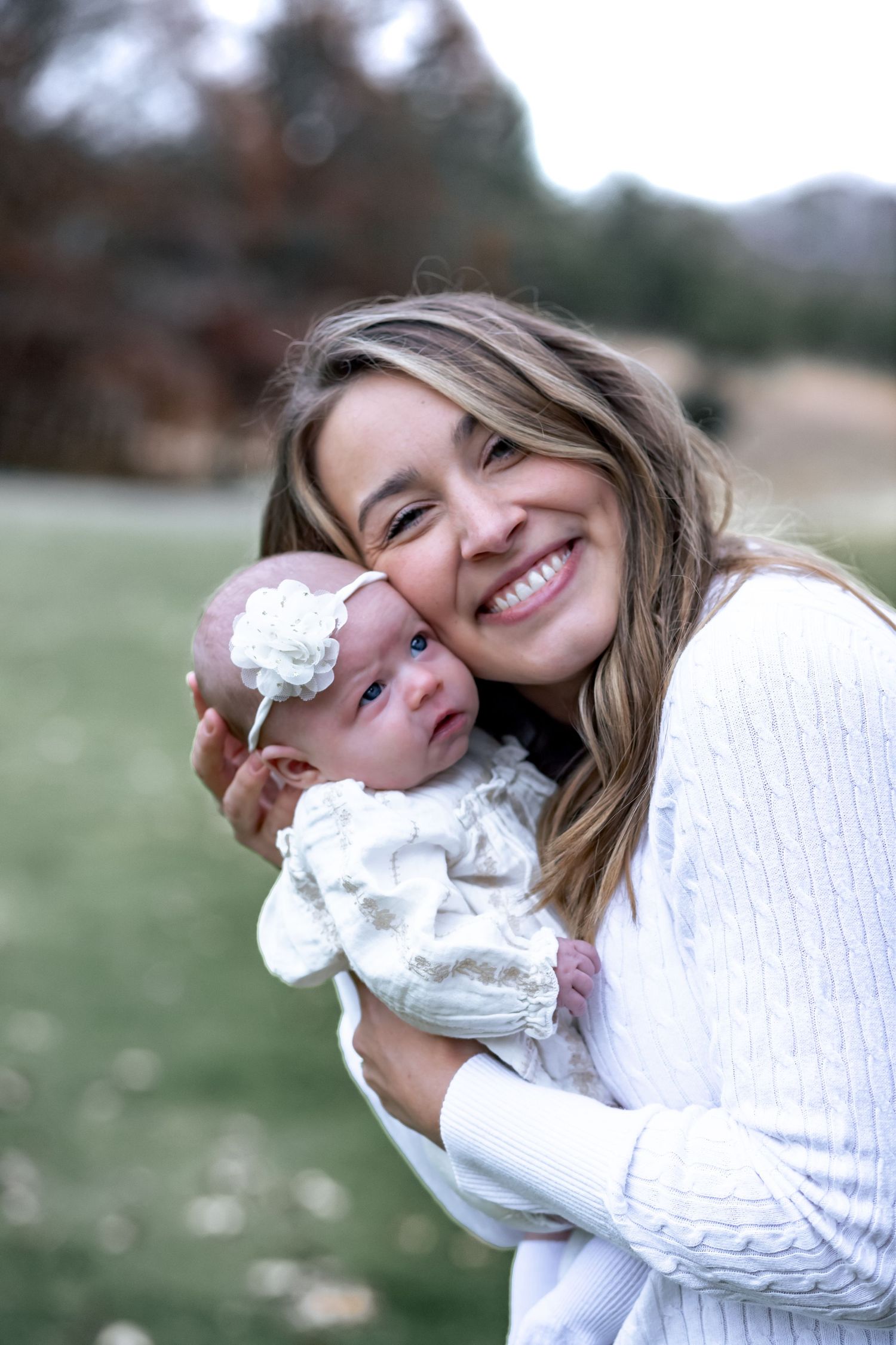 A playful portrait sequence showing someone in a white sweater holding a small white puppy outdoors.