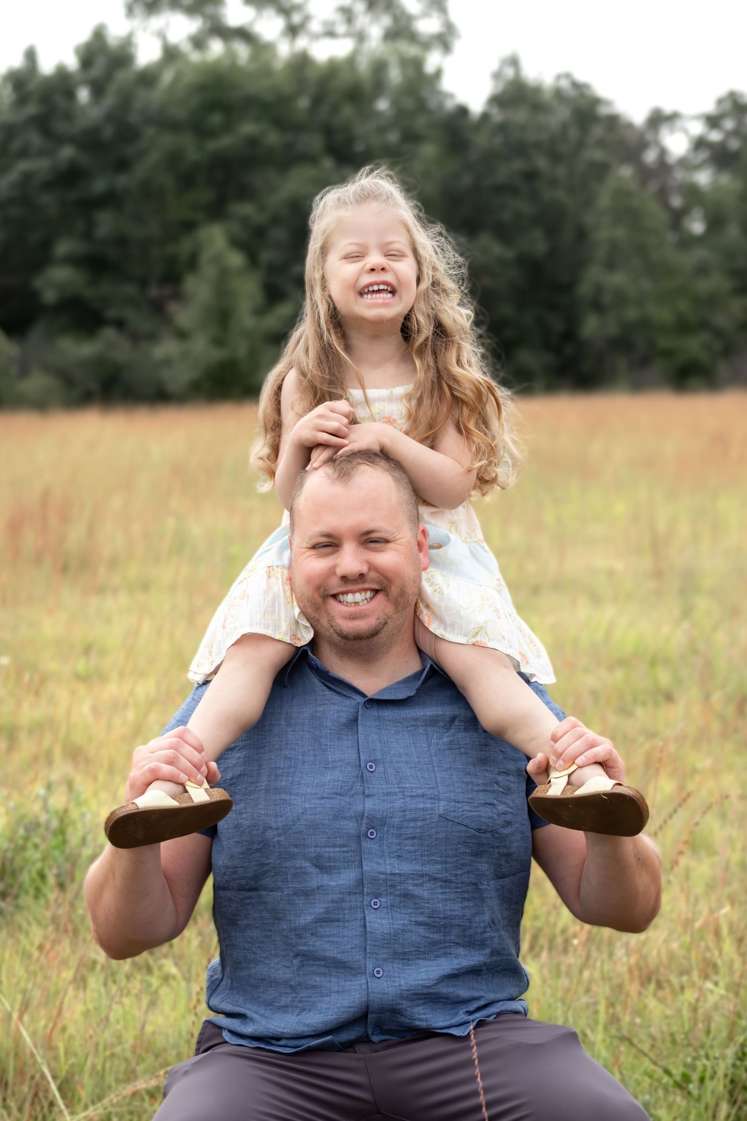 Progressive series of joyful family poses in a sun-drenched field with natural backdrop.
