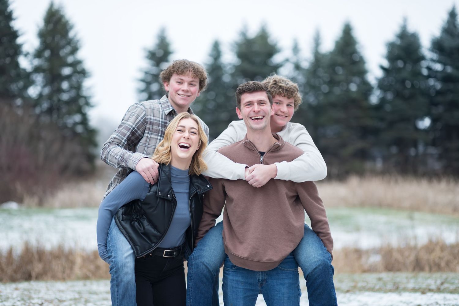 family_photography_lino_lakes_mn_piggyback_laughing_at_camera.jpg