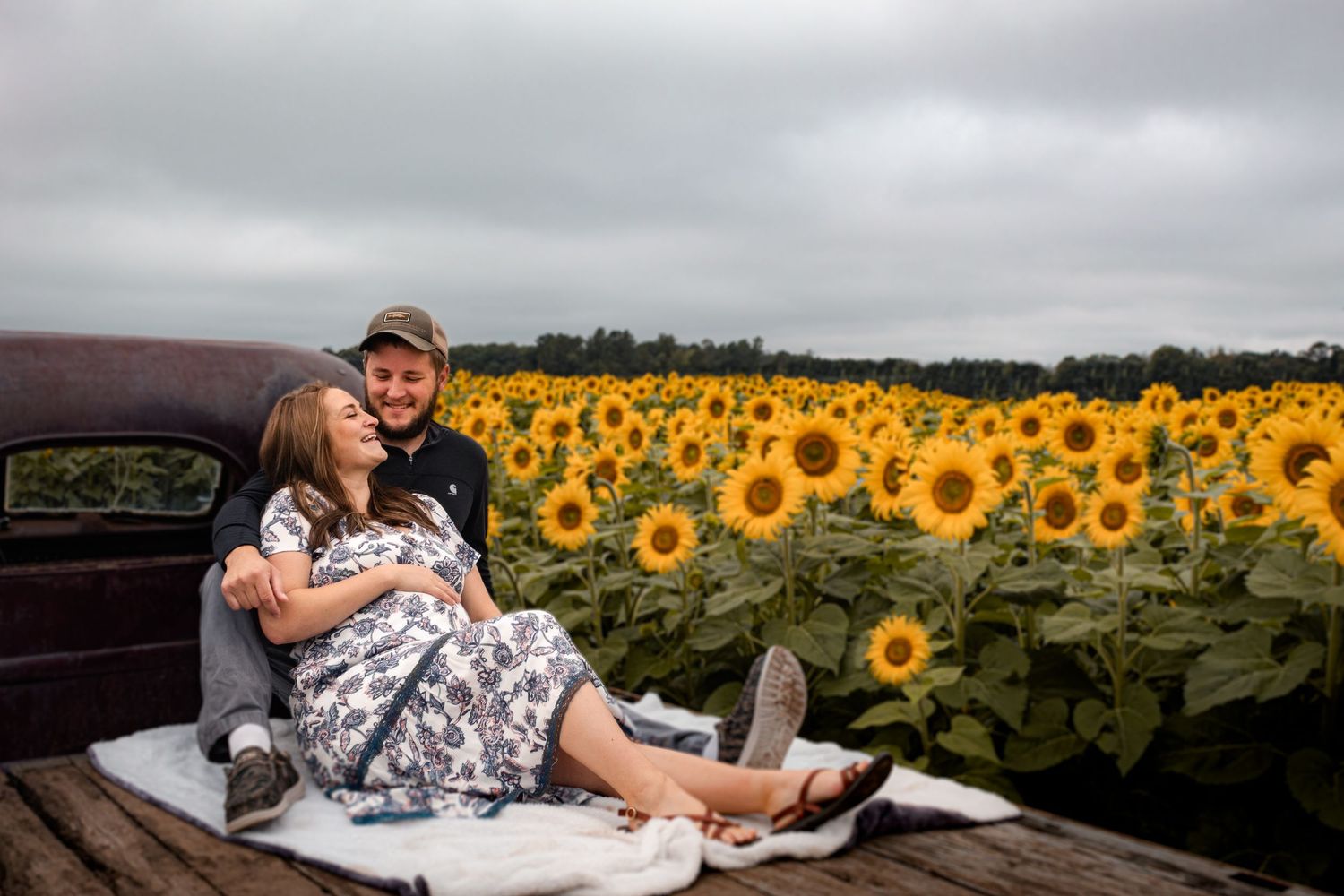 sunflower field maternity session, sitting on the back of vintage pickup truck
