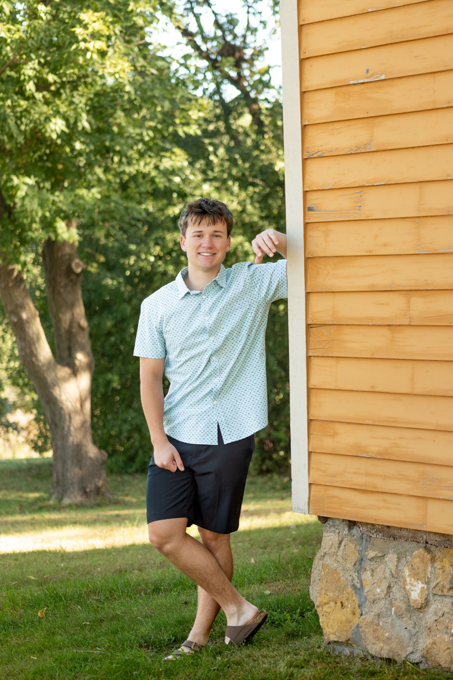 Casual poses against a wooden building exterior in natural lighting.