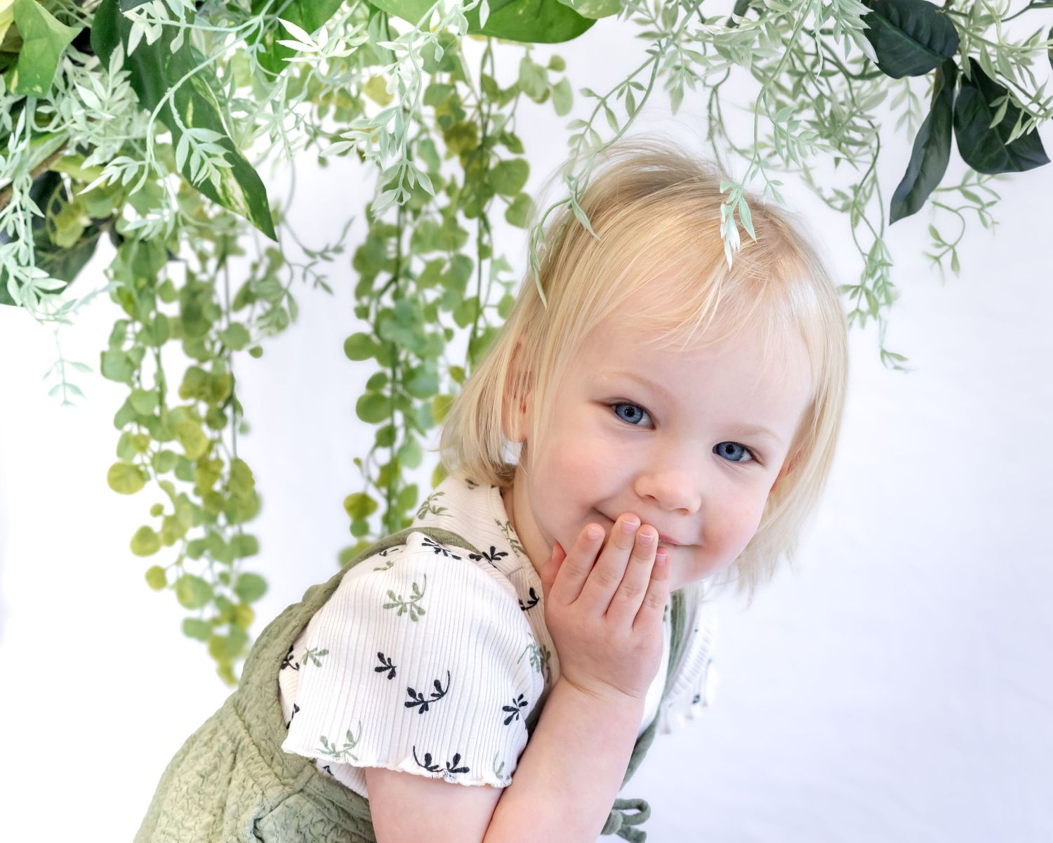moments along the way, little girl with greenery in front of white background