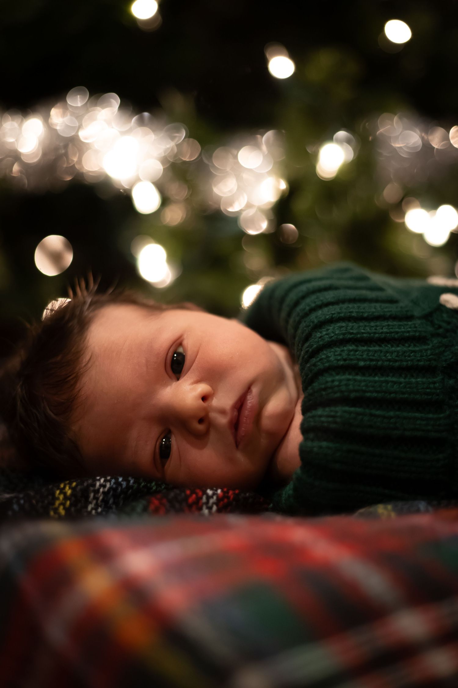 Artistic portrait with twinkling lights and bokeh effects creating a dreamy holiday atmosphere.