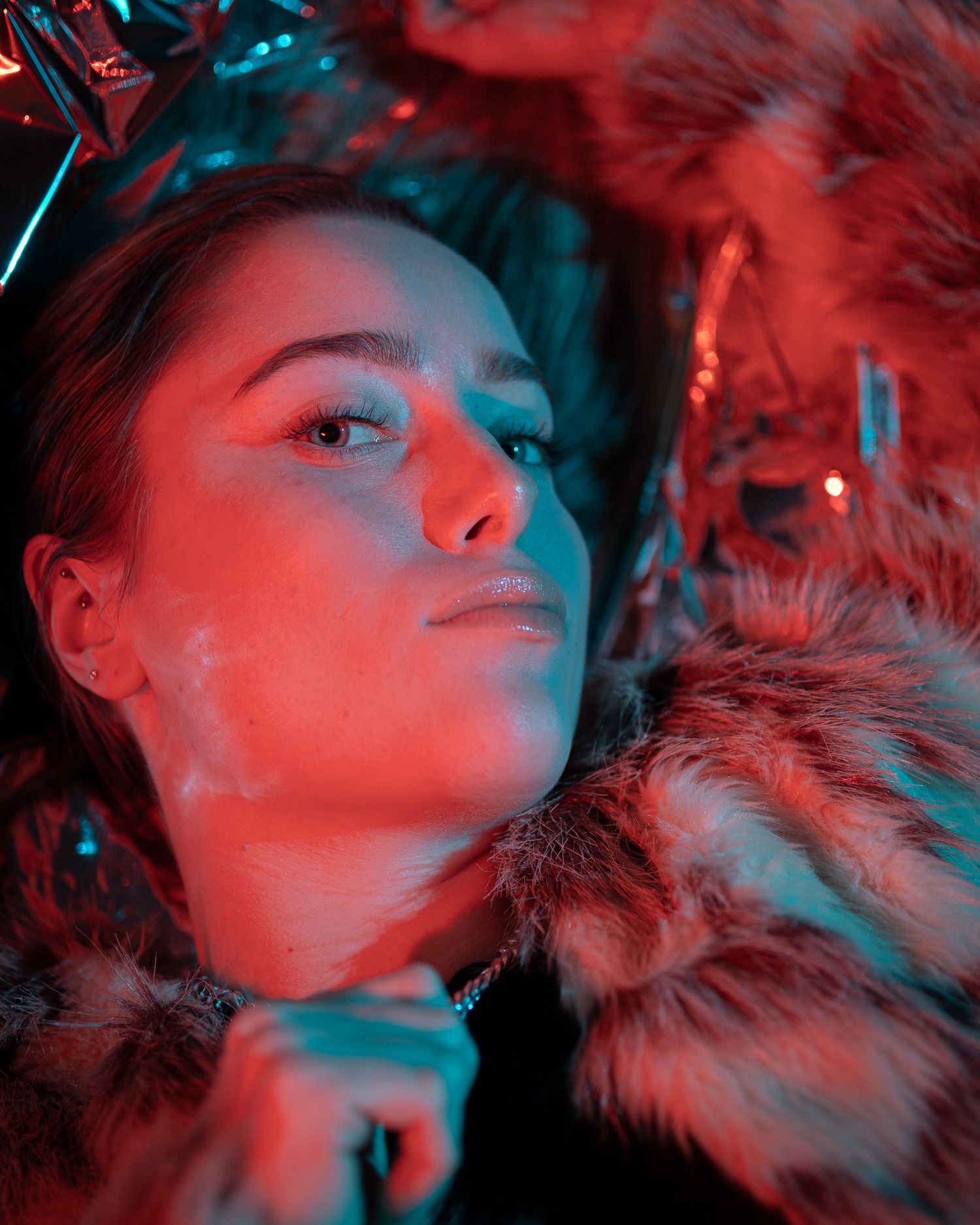 Dramatic red and blue lit portraits with fur texture creating a moody atmosphere.