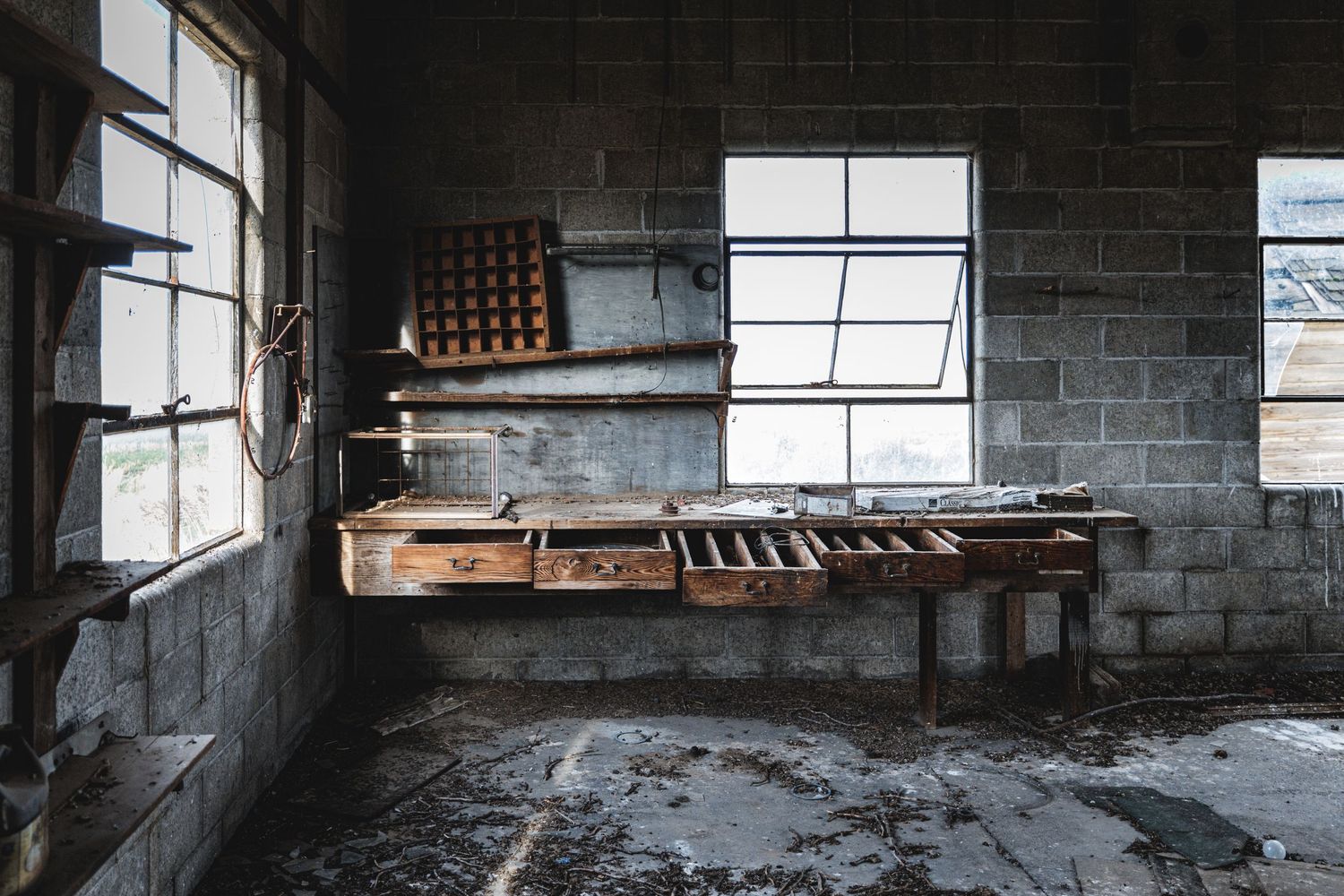 Industrial space with concrete block walls and large windows letting in natural light.