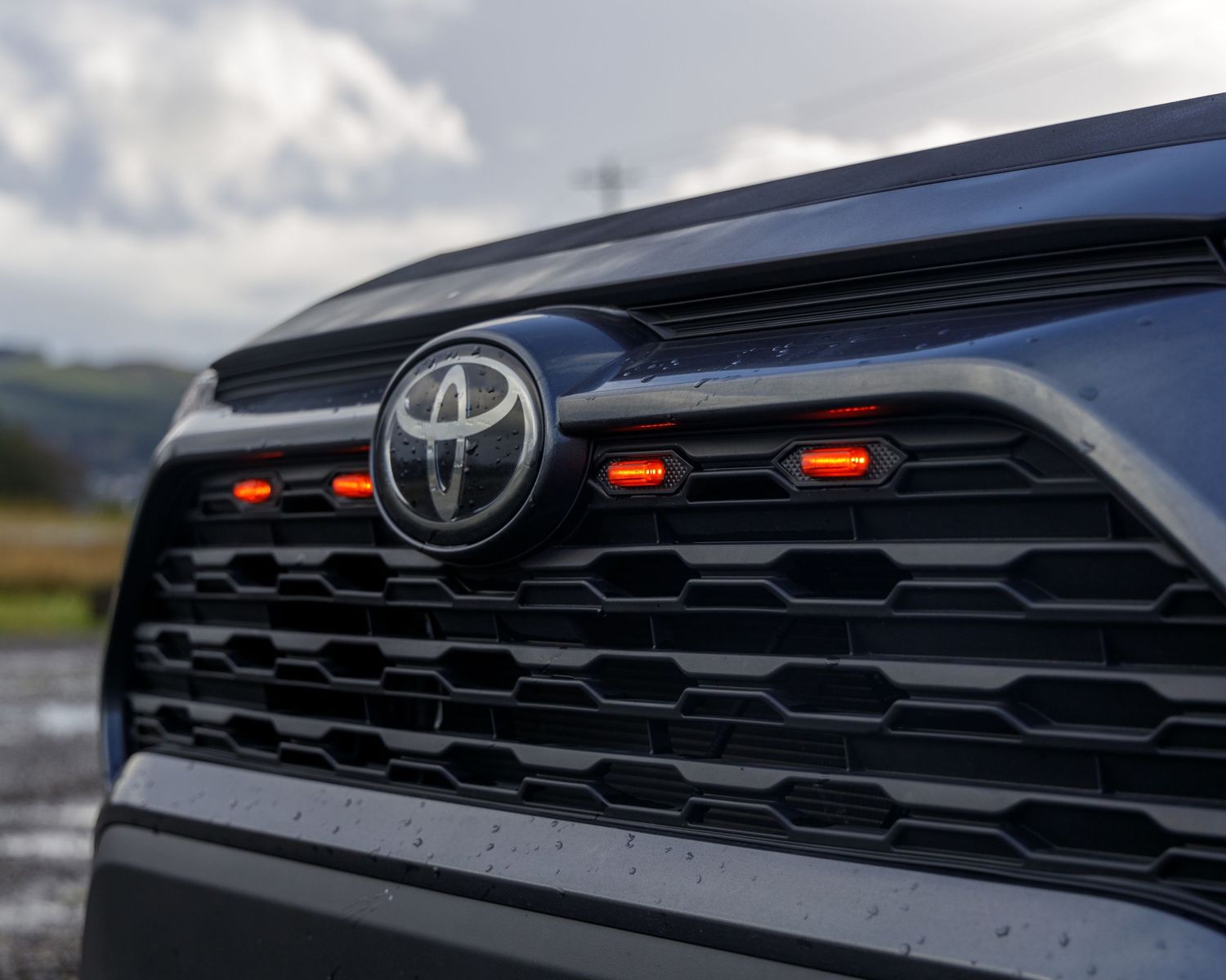 Close-up detail of Toyota vehicle grille and front emblem design.