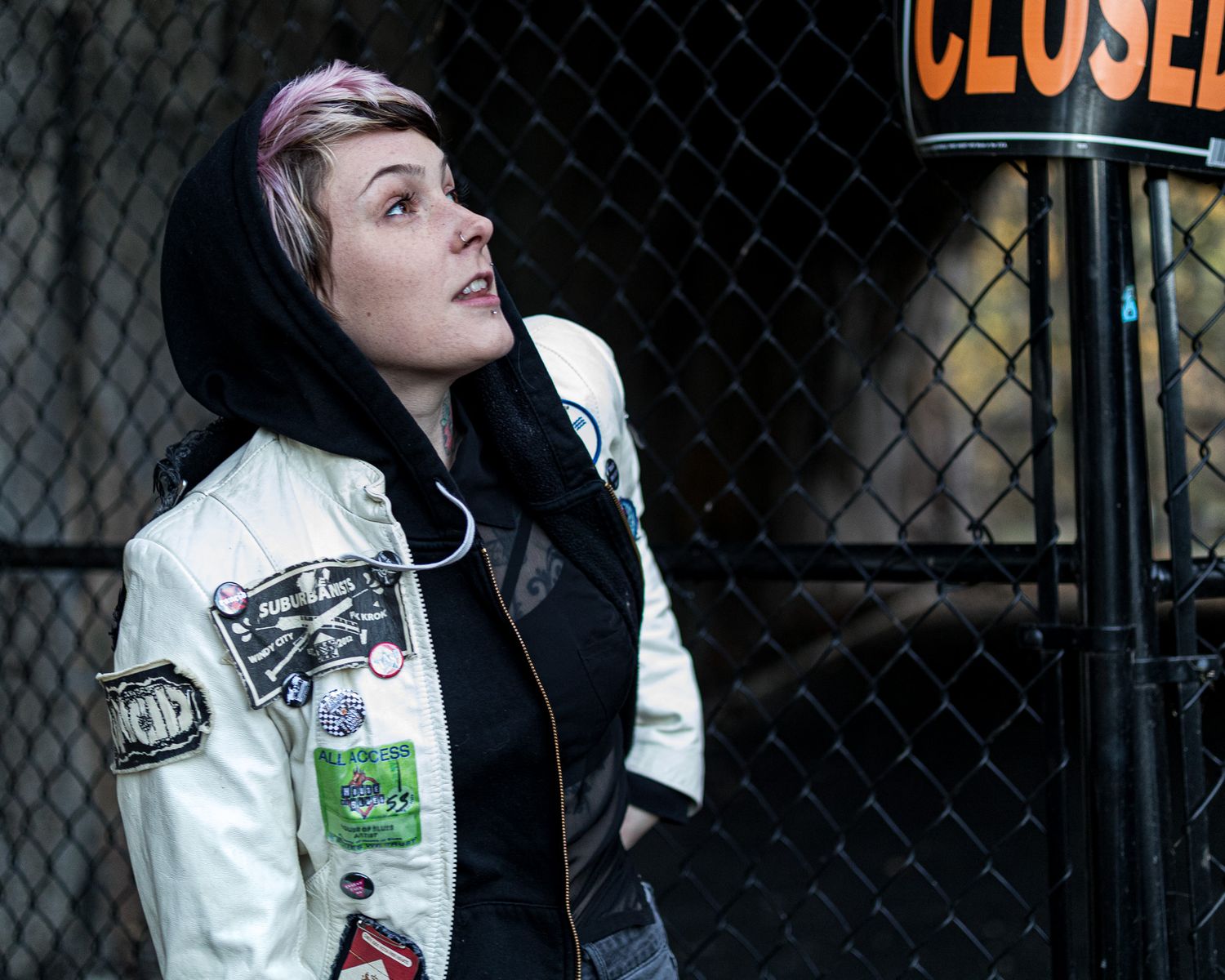 Urban fashion shots against a chain link fence with a 'CLOSED' sign visible.