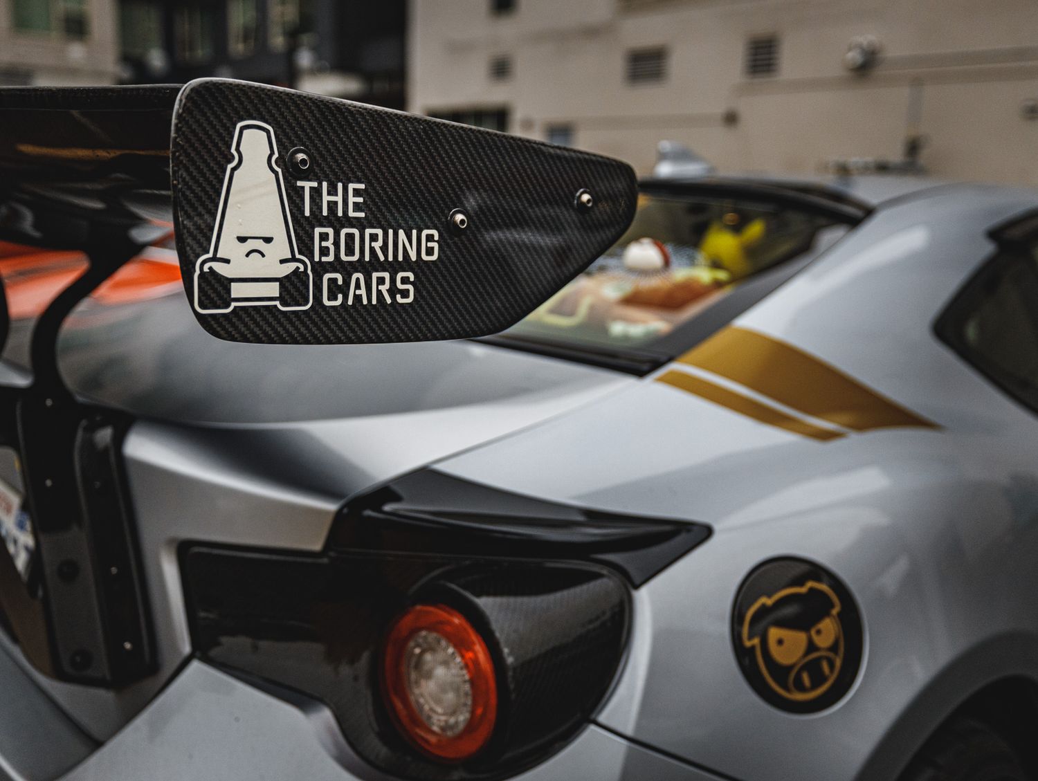 Custom sports car rear wing and taillights with performance modifications.