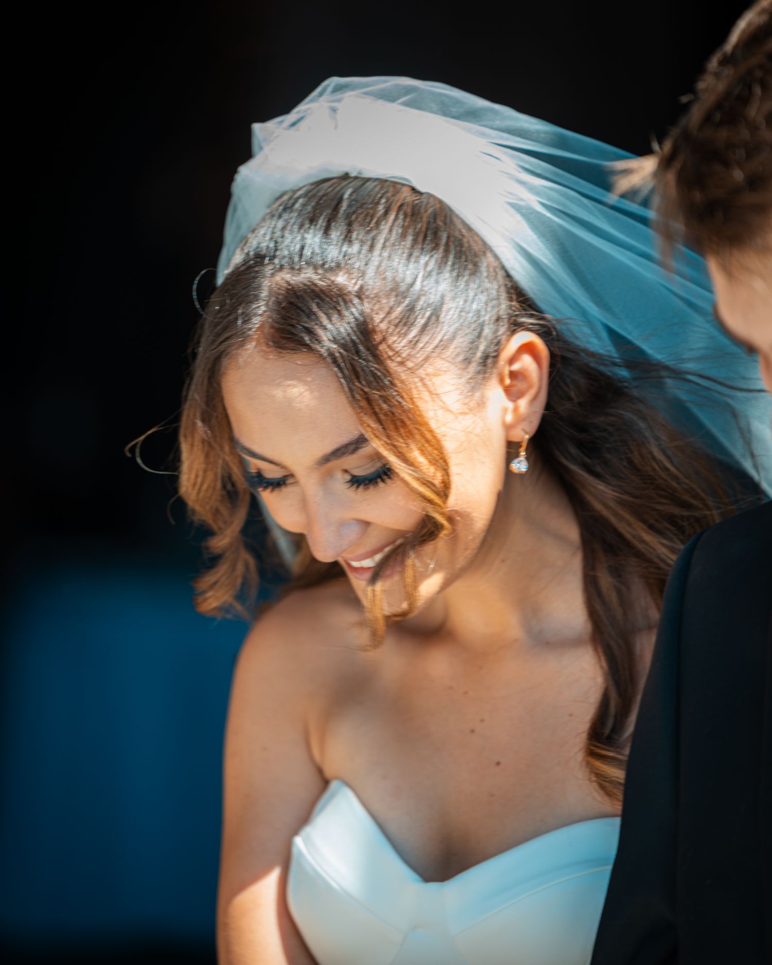 Close-up shots of a bride in white dress and veil with soft natural lighting highlighting her features.