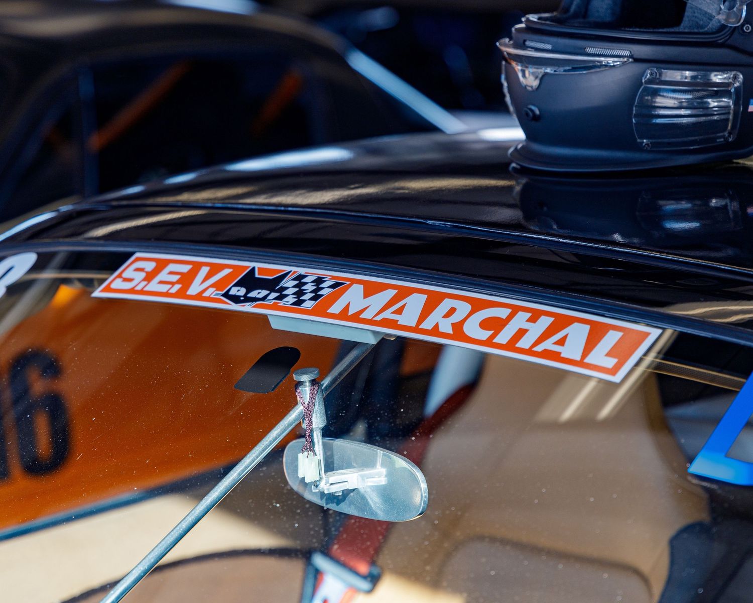 Close-up detail shots of a modified white vintage Japanese car with Marchal branding and racing accessories.