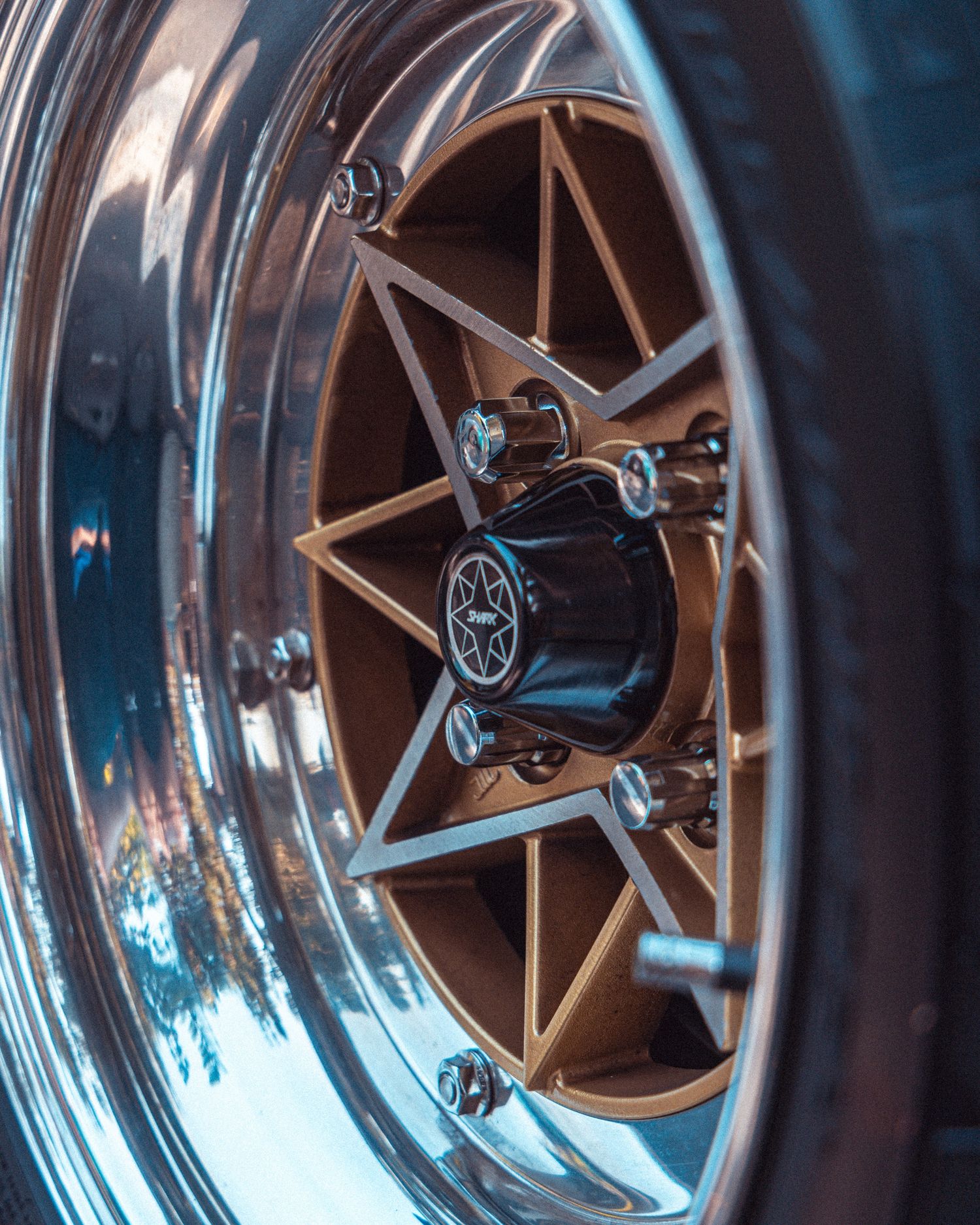 Detail shot of polished chrome wheel rims with multi-spoke design reflecting light.