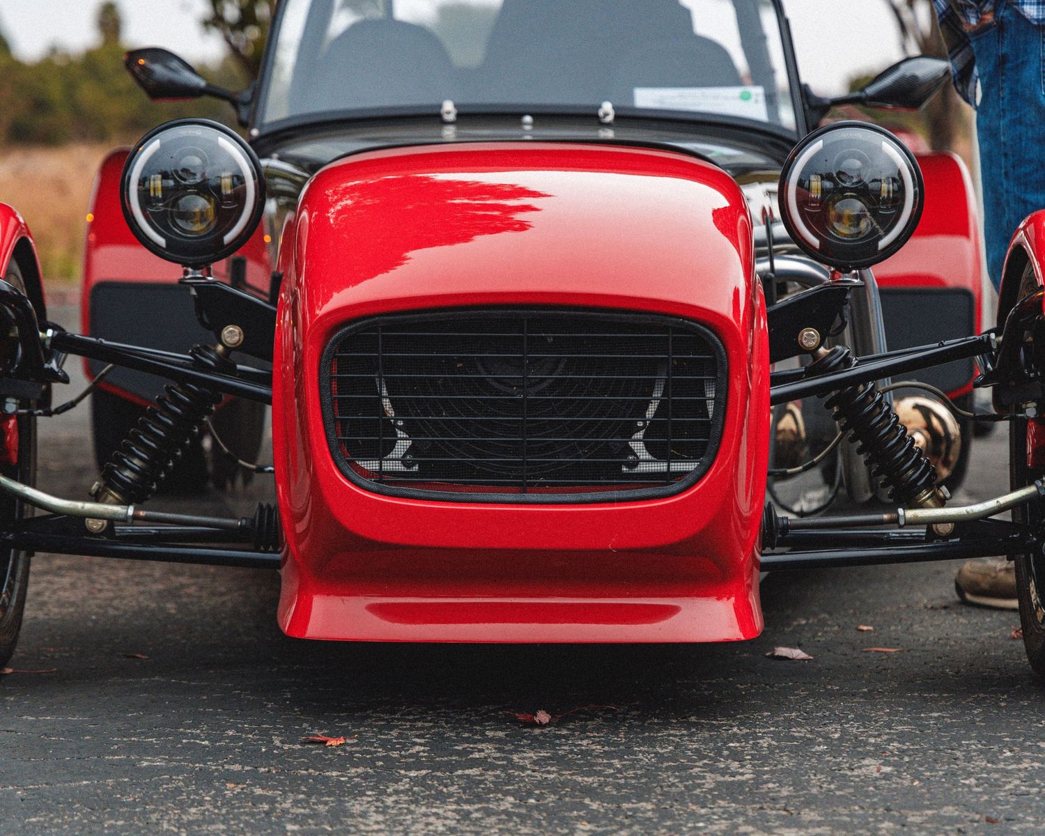 Collection of vintage red sports car front ends showing classic grilles and headlights.