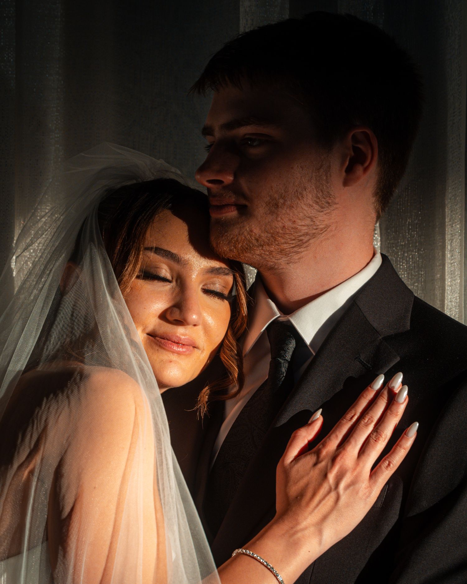 Dramatic black and white wedding portraits showing intimate moments between the newlyweds.