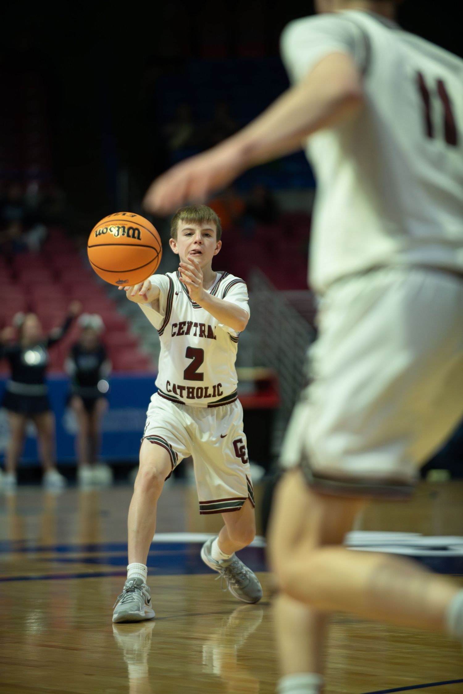 Basketball player in white uniform sets up for a shot during game play.