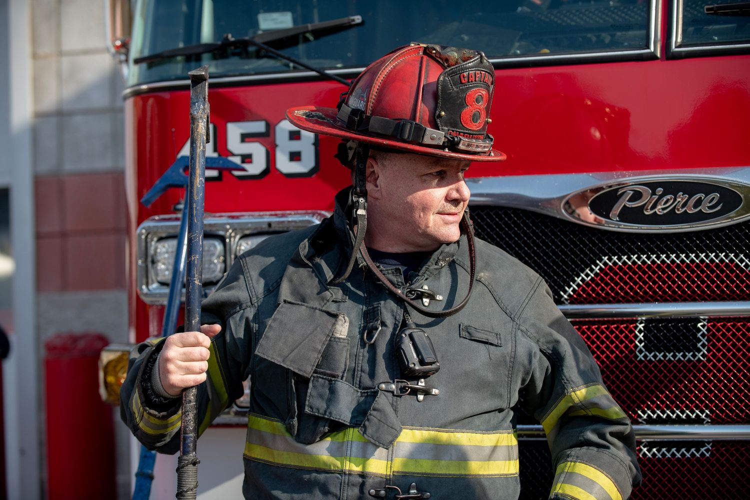 Firefighters in protective gear aim water hoses during an emergency response exercise.