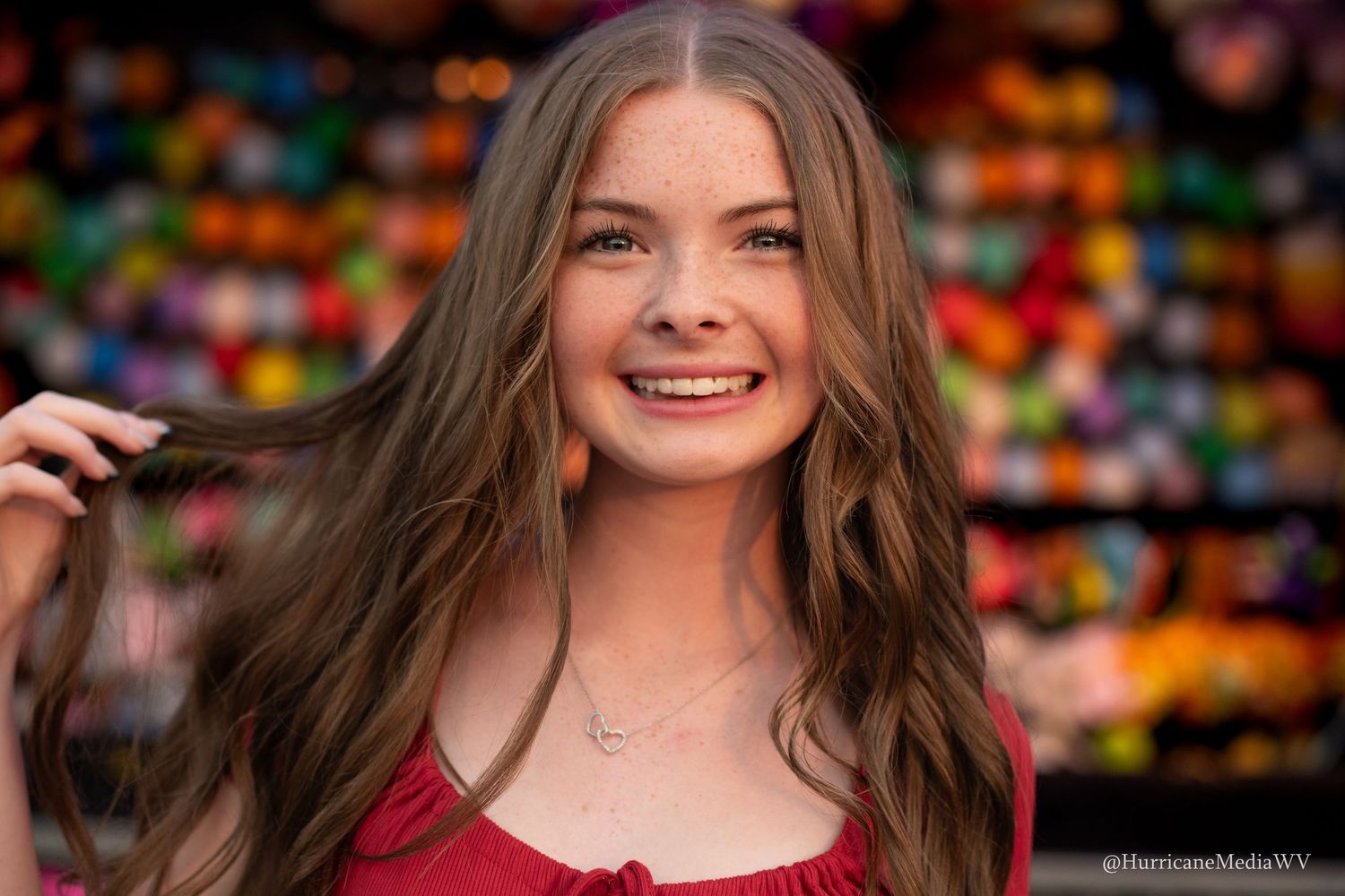 A cheerful portrait with vibrant bokeh lights creating a festive background atmosphere.