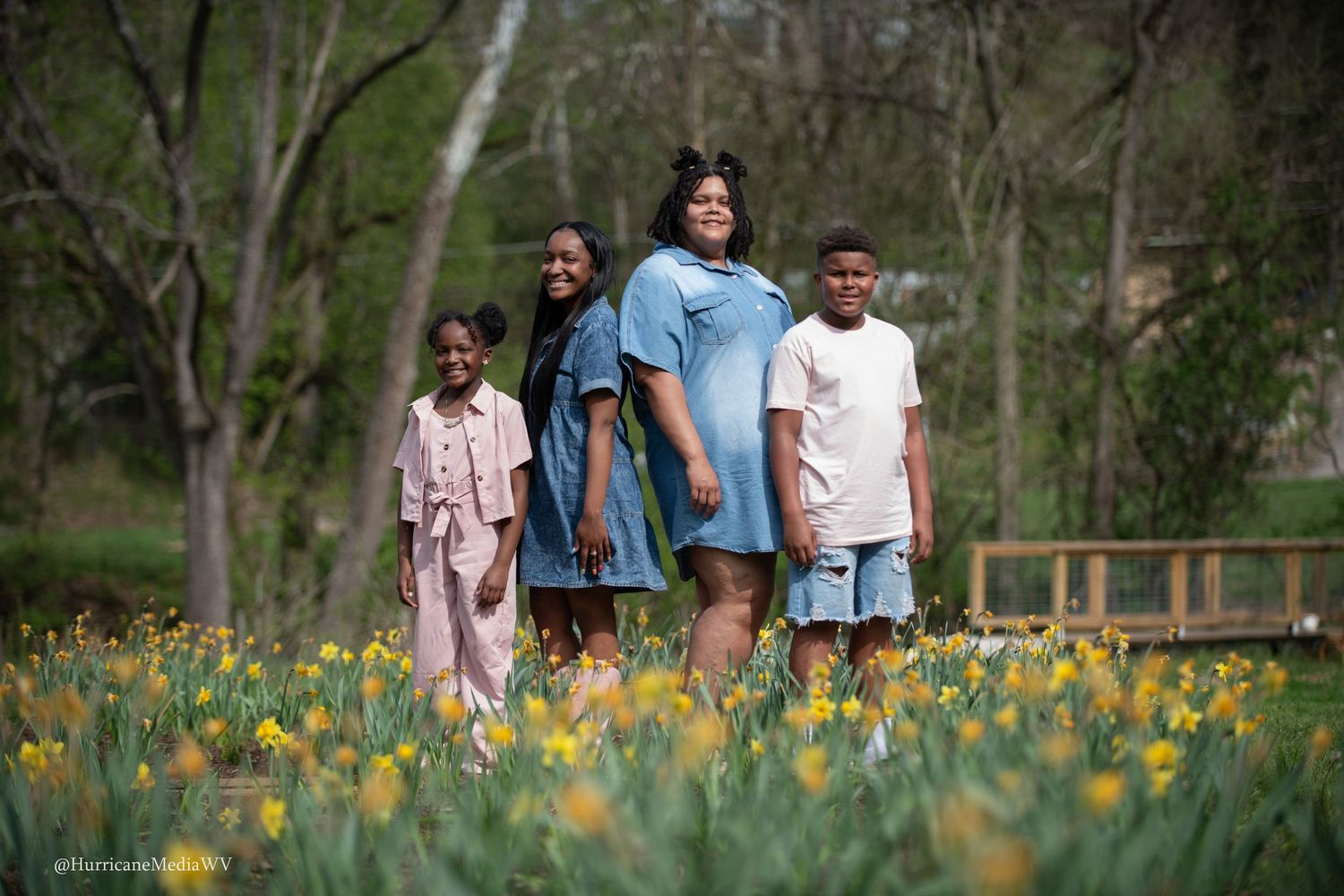 Family enjoying a spring day among blooming daffodils in a park setting.