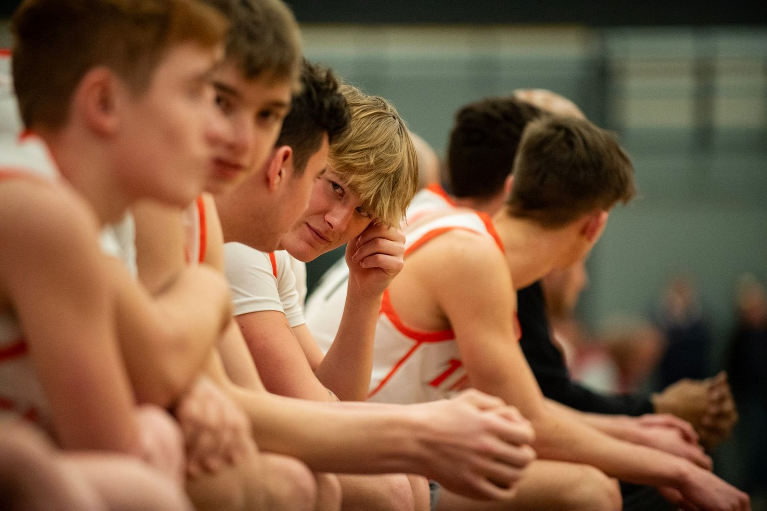 Athletes lined up in a row during a sporting event.