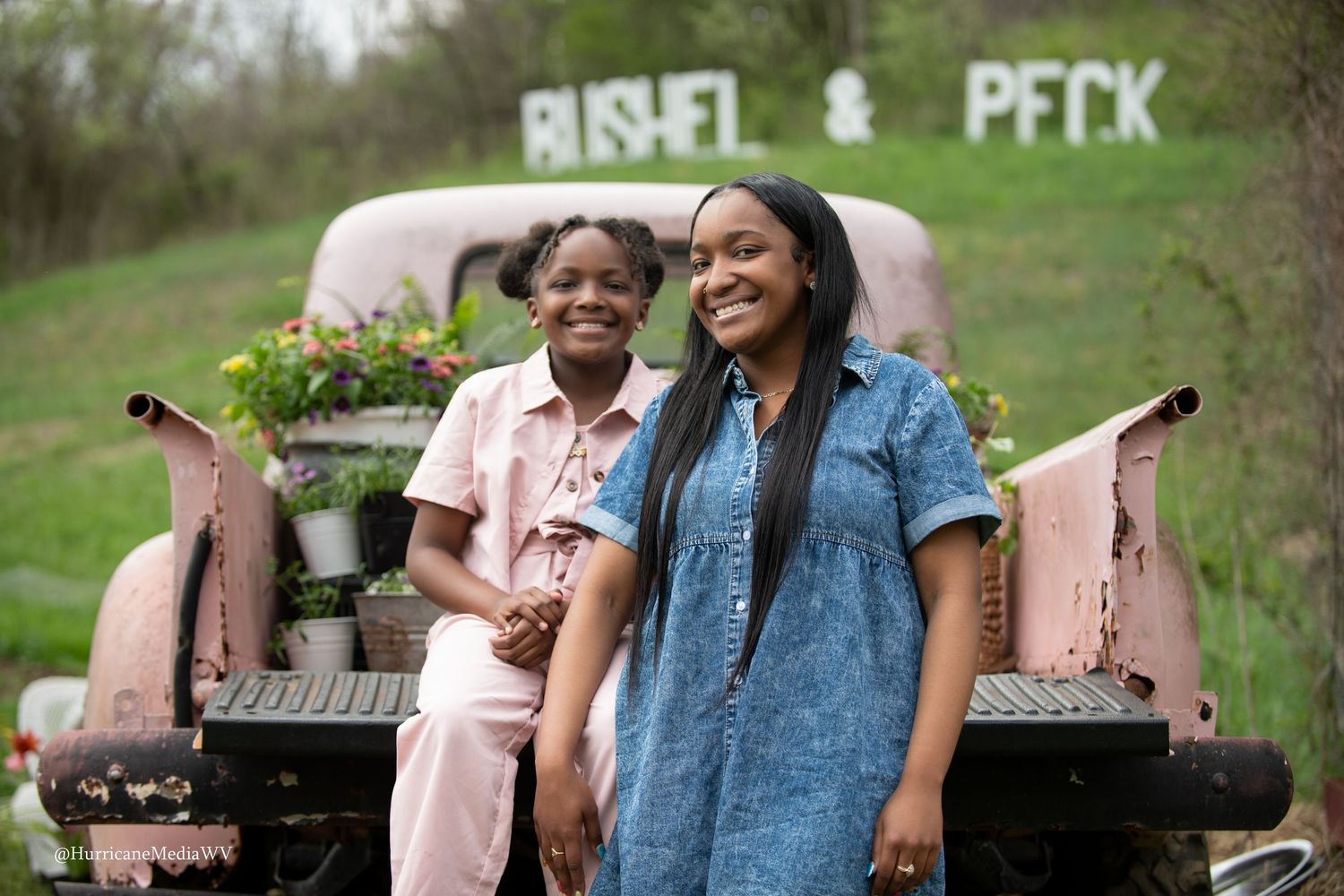 Outdoor portrait session featuring casual attire and vintage pink furniture.