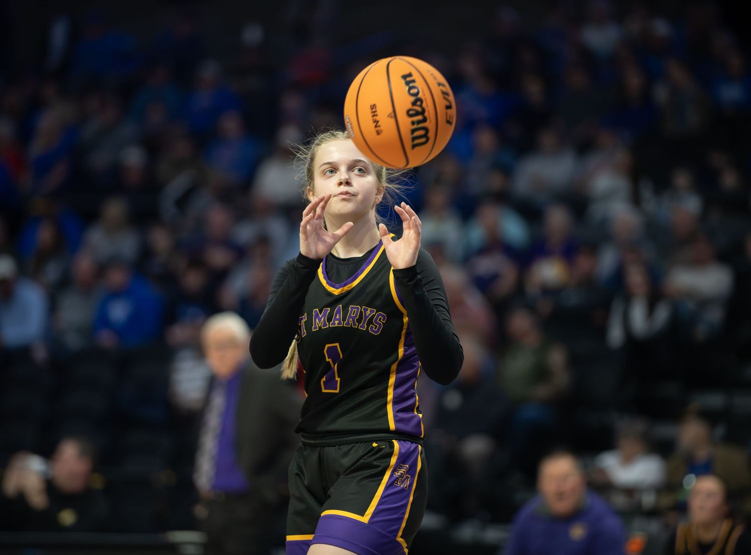 Basketball player in yellow Lakers jersey dribbles the ball during NBA game against Orlando Magic.