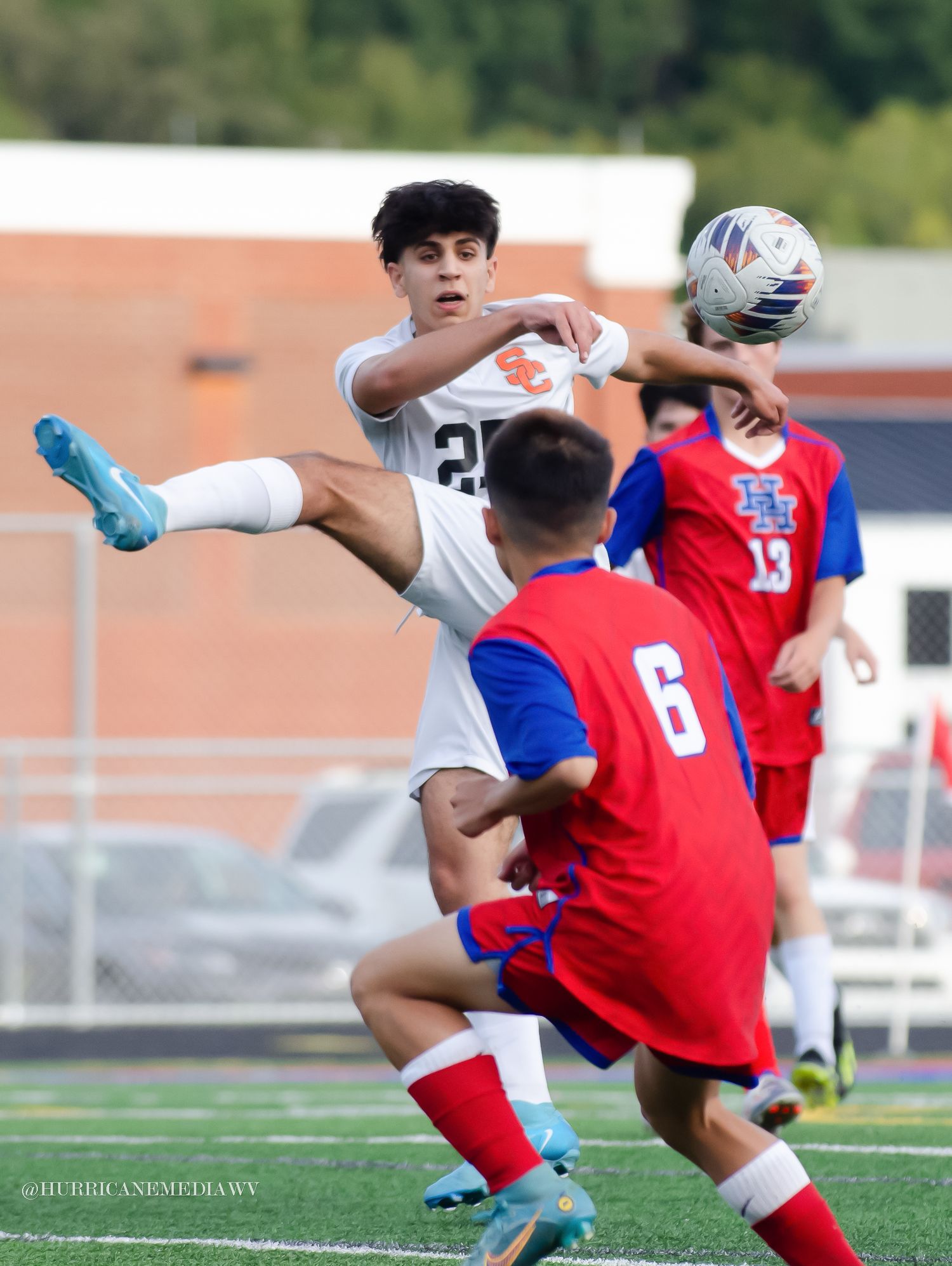 Intense soccer action with players colliding during competitive match.