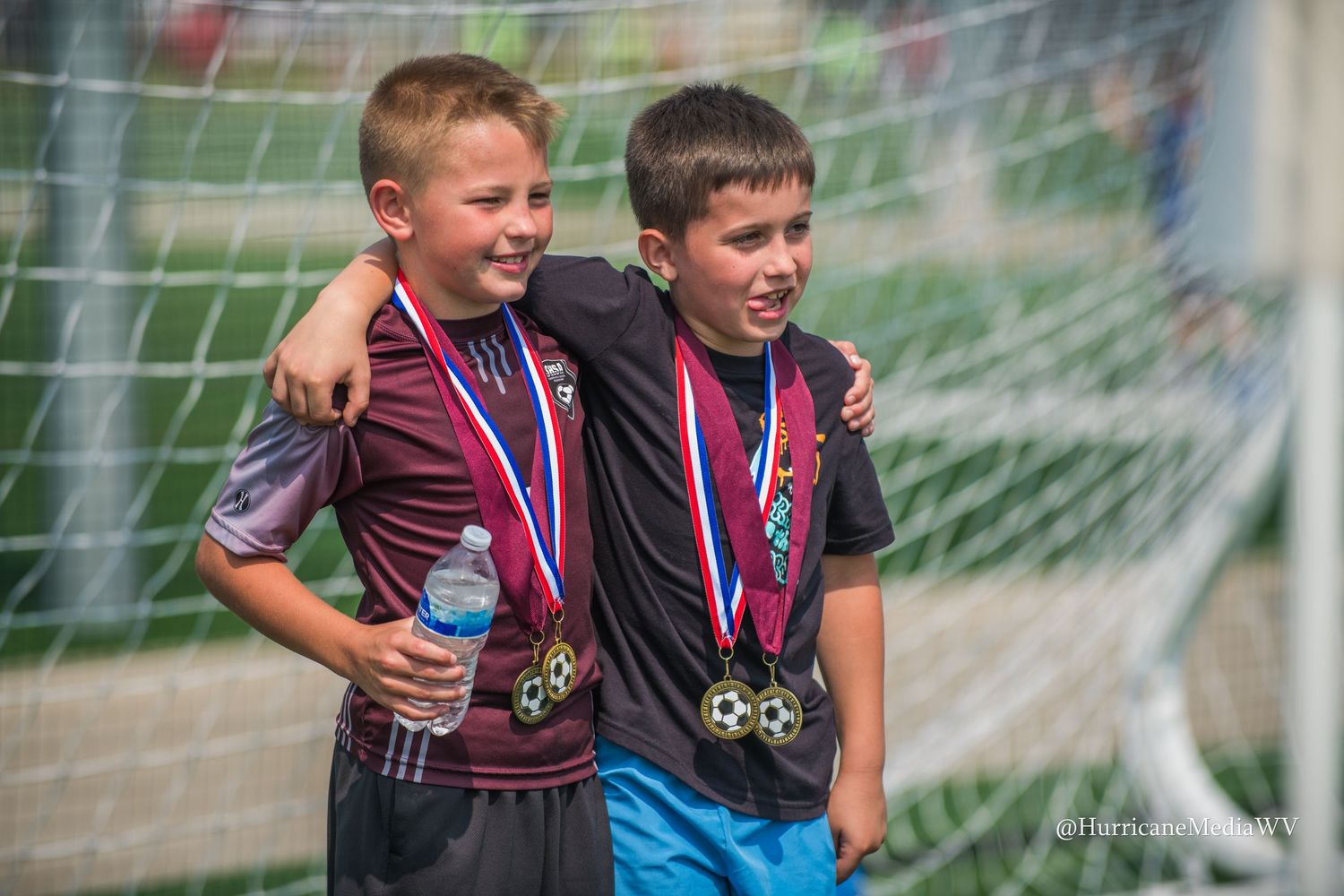 Young athletes celebrating with medals after a soccer match.
