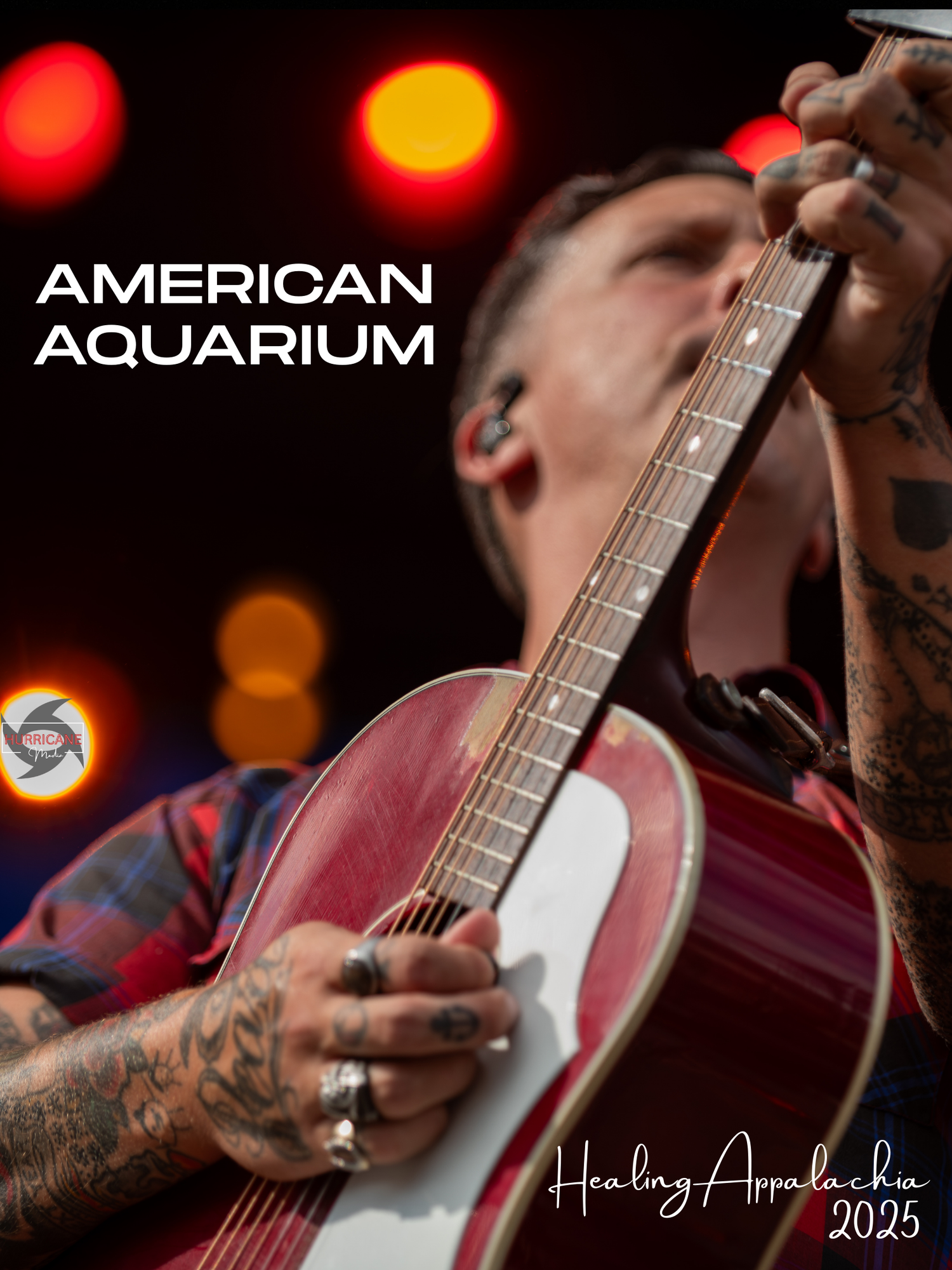 Musician performs on stage with a banjo against red and orange lighting effects at a concert venue.