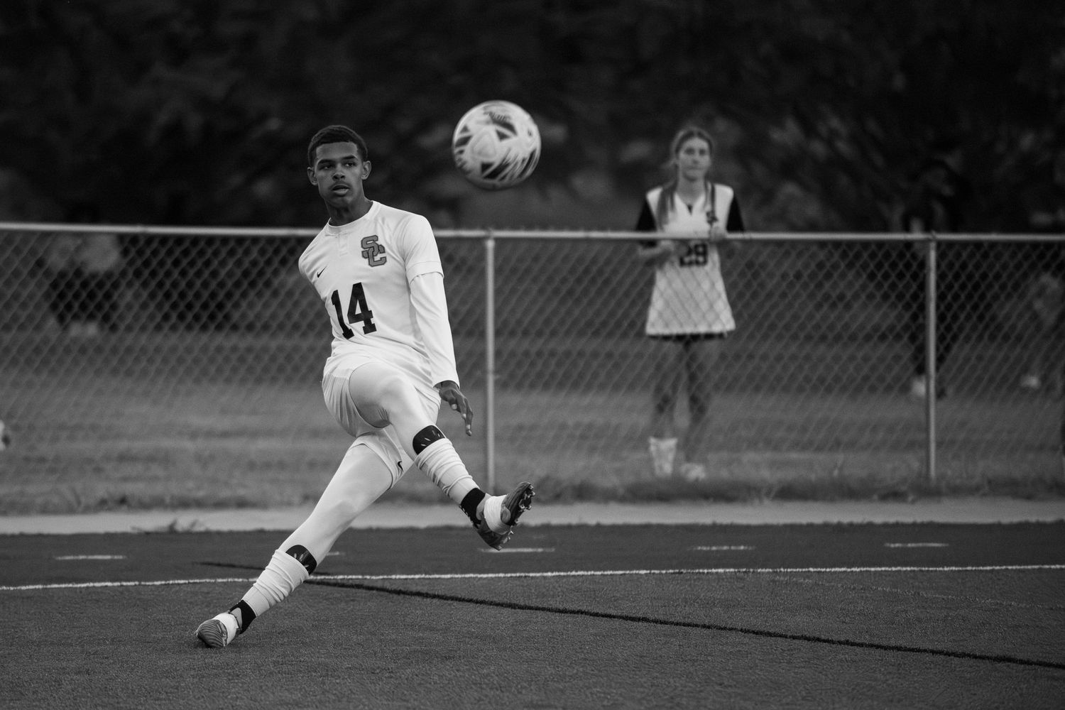 A series of black and white soccer action shots showing diving saves and athletic goalkeeping moments during a match.