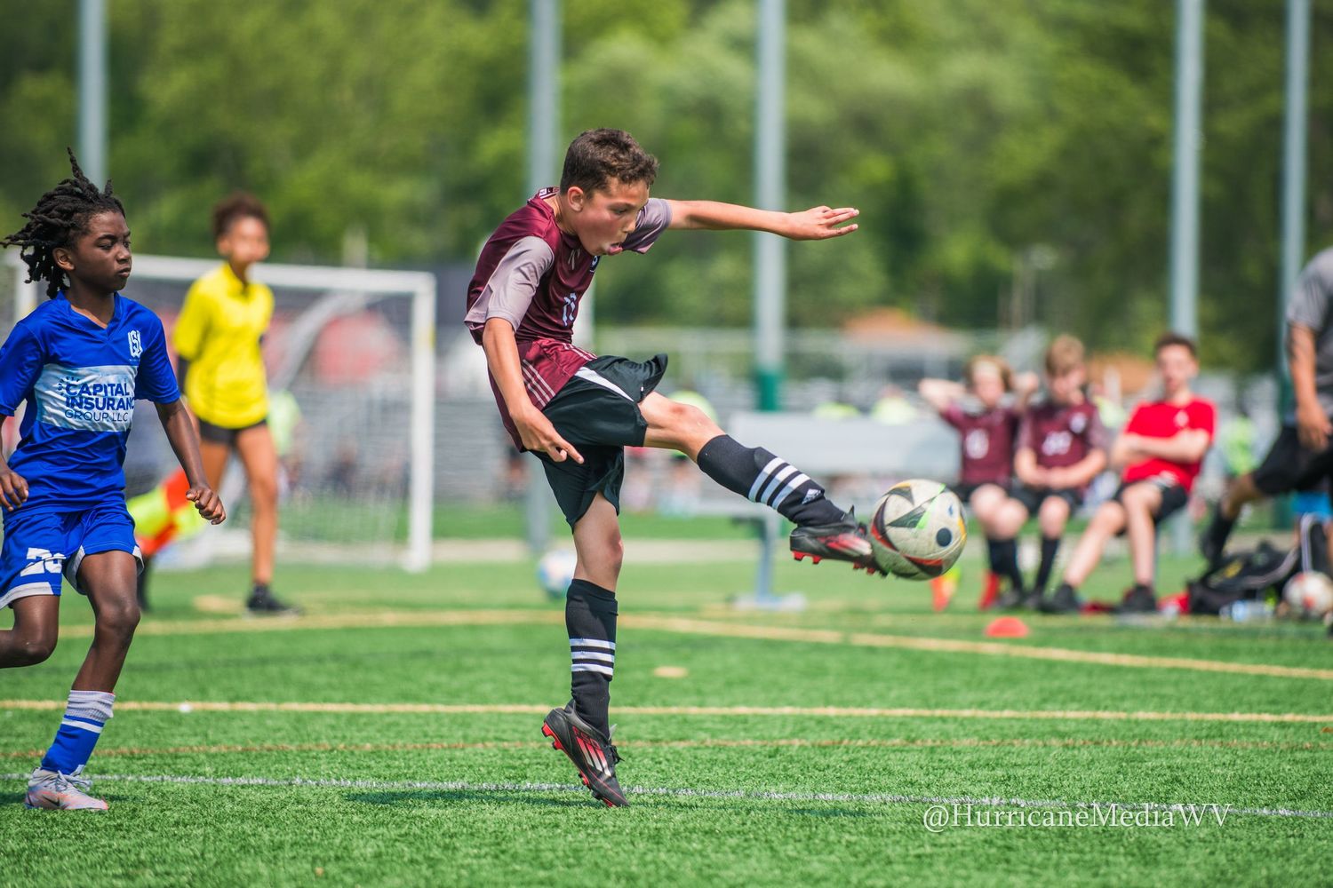 Soccer players in action on a sunny field during a match.