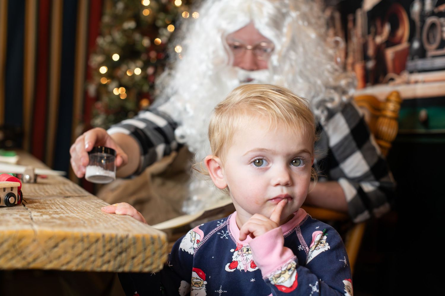 A collage of holiday photos showing children opening presents and enjoying Christmas festivities near a decorated tree.
