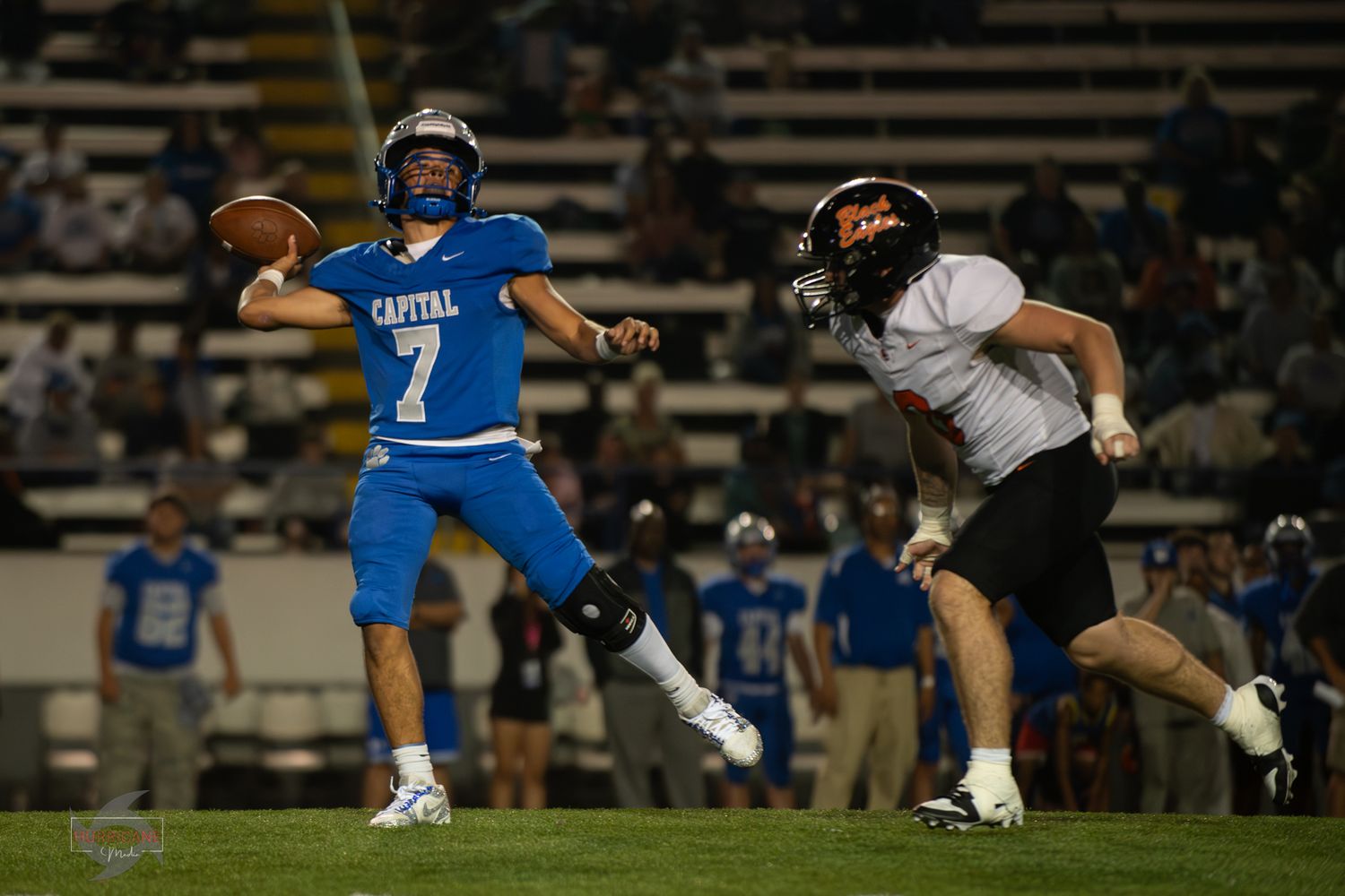 Football players engage in a high-intensity tackle during a competitive game on the field.